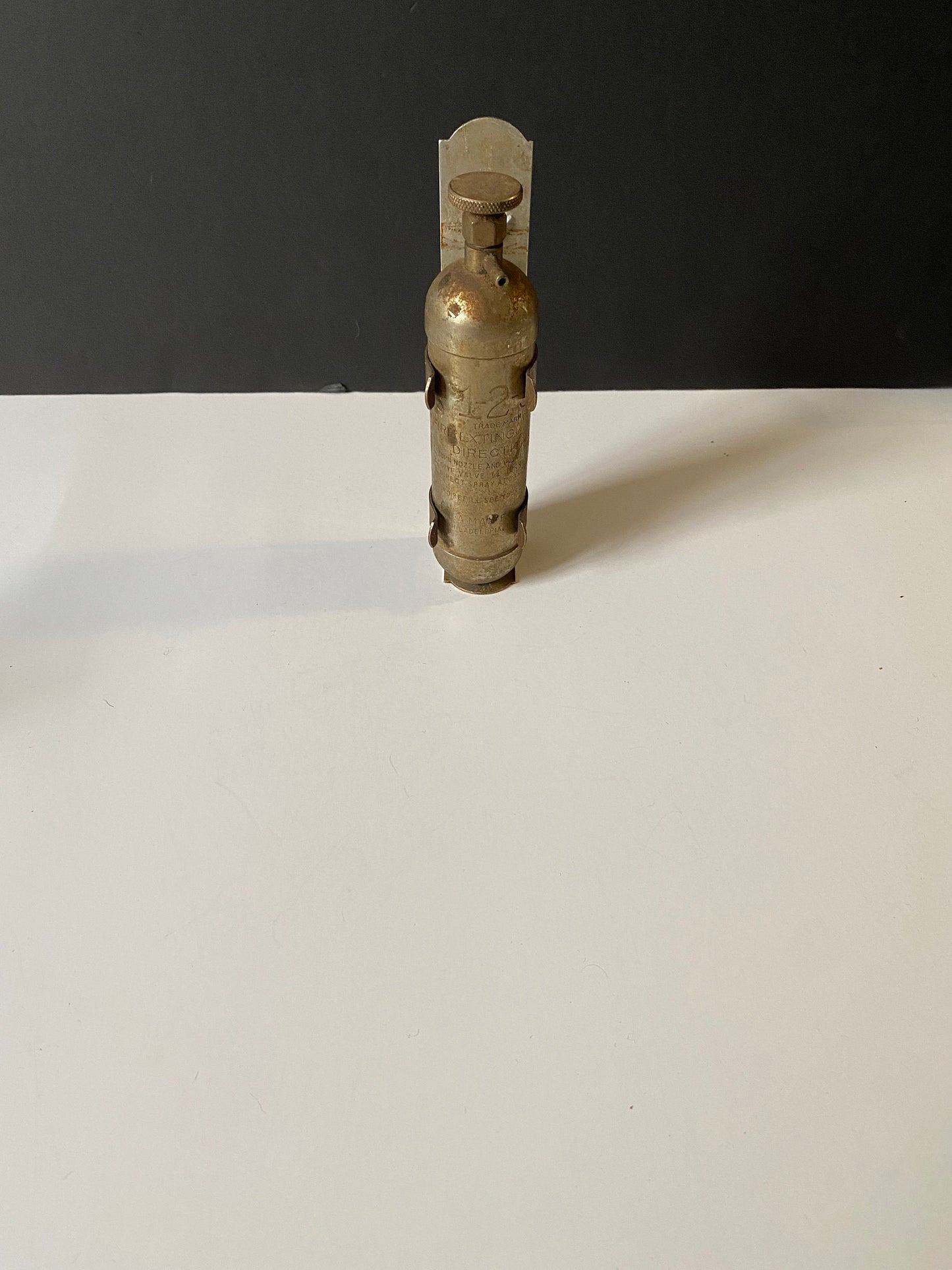 A 8 inch salesman sample fire Extinguisher with bracket very old very cool Philadelphia