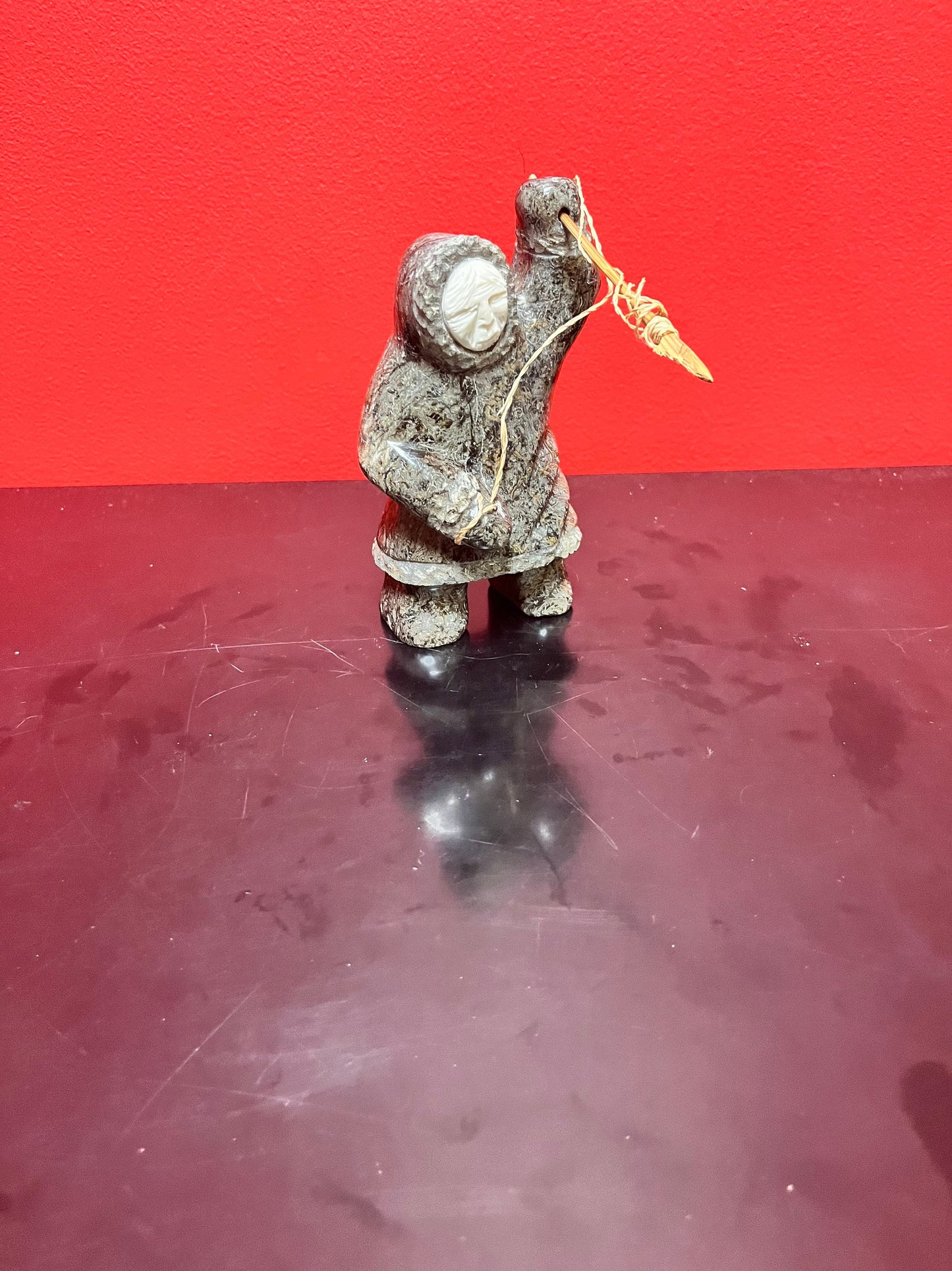 A  Fabulous 6 inch tall, authentic indigenous Inuit soapstone hunting statue with carved bone face  antique Inuit soapstone