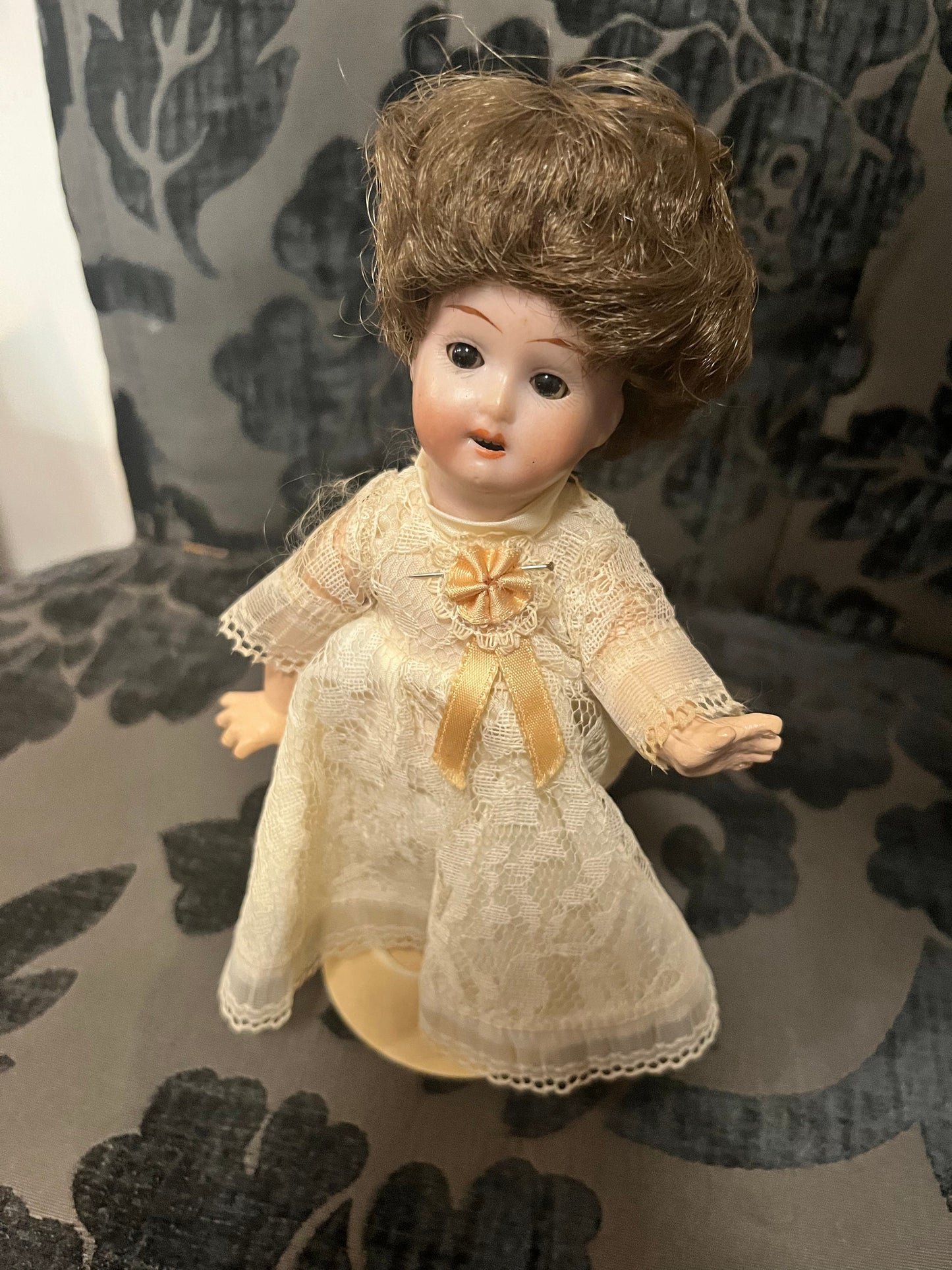 8 1/2 inch Victorian porcelain doll with original clothes on stand