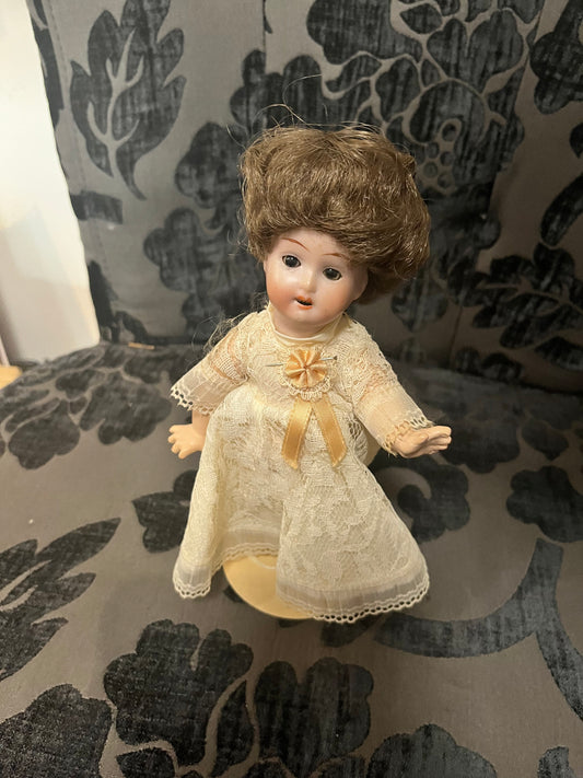 8 1/2 inch Victorian porcelain doll with original clothes on stand