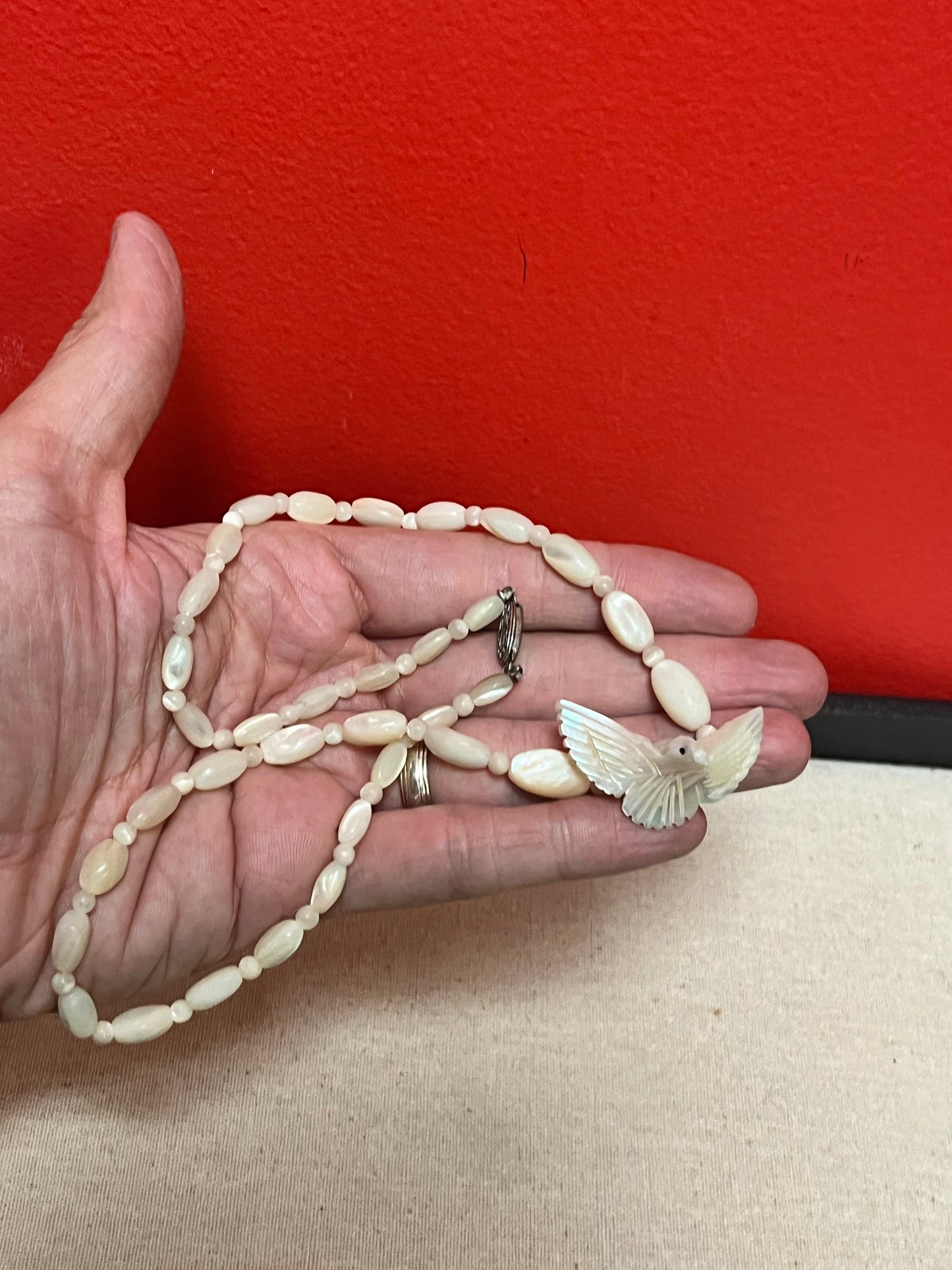 Approximately 21 inch carved shell necklace with bird pendant lovely detail