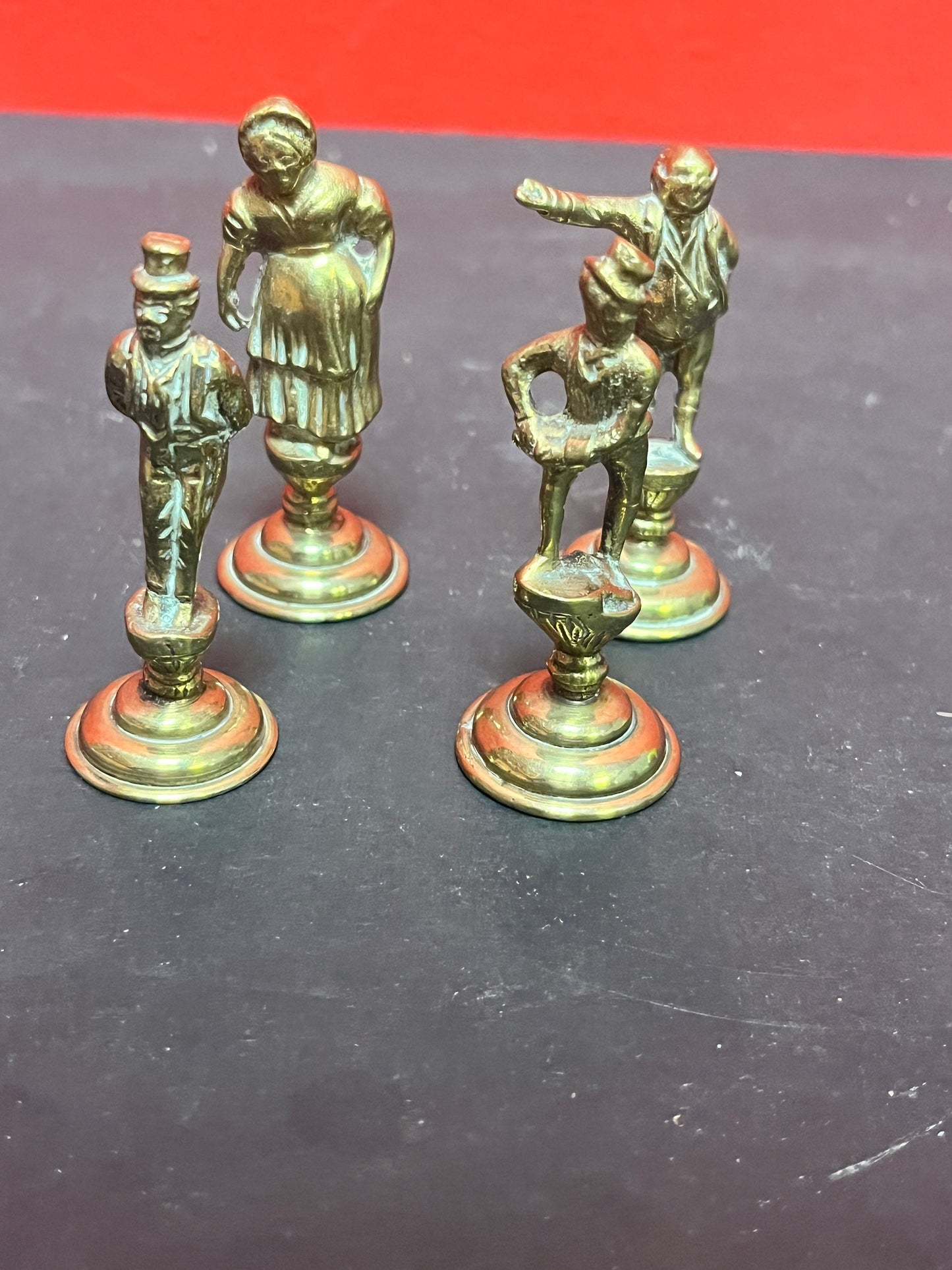 Lovely antique set of four brass Dickens character pipe tampers wonderful set in great condition and 2. 5 inches high each.