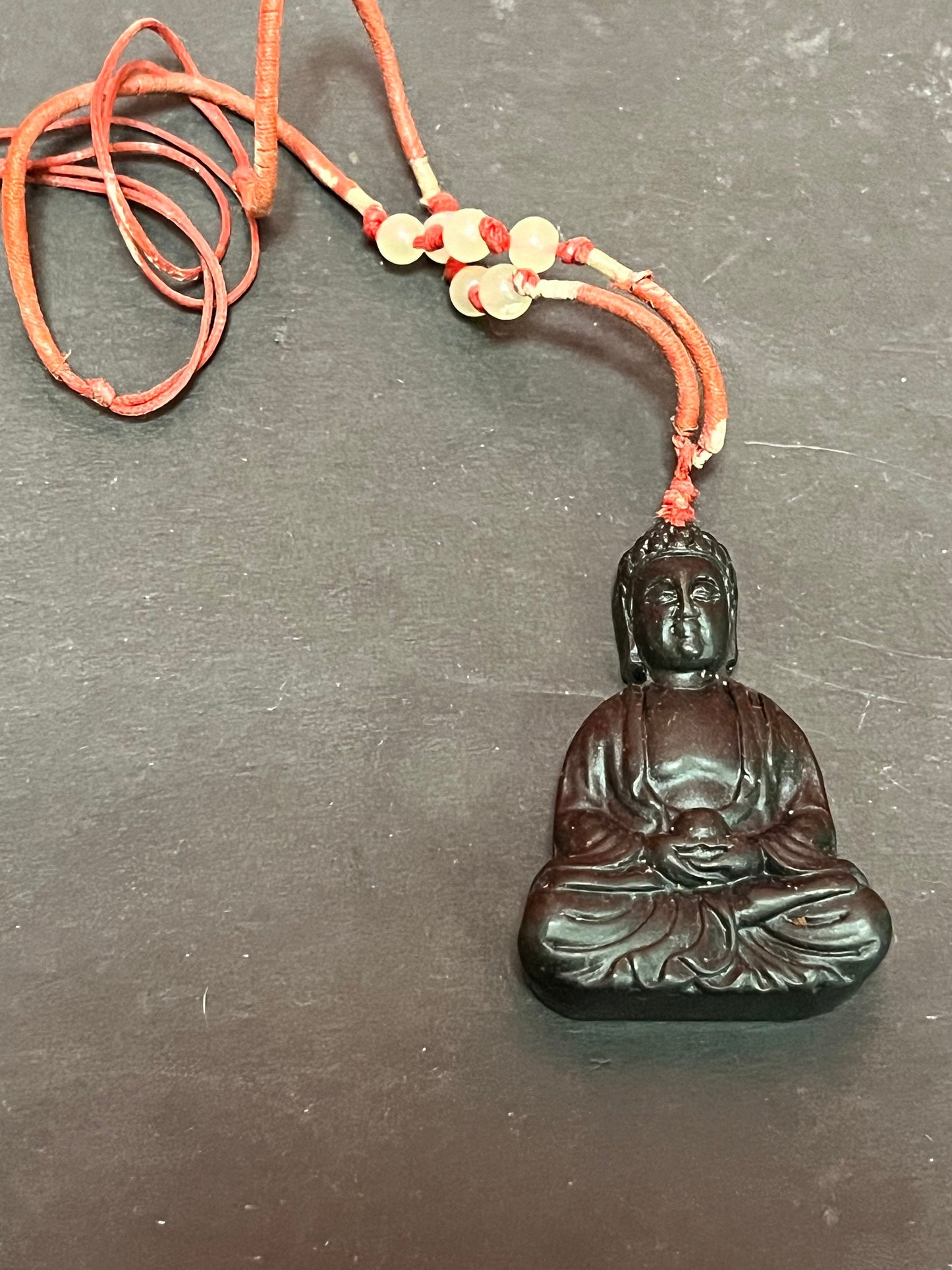 2.5 inch long older Asian black stone, Buddha pendant with original necklace lovely detail
