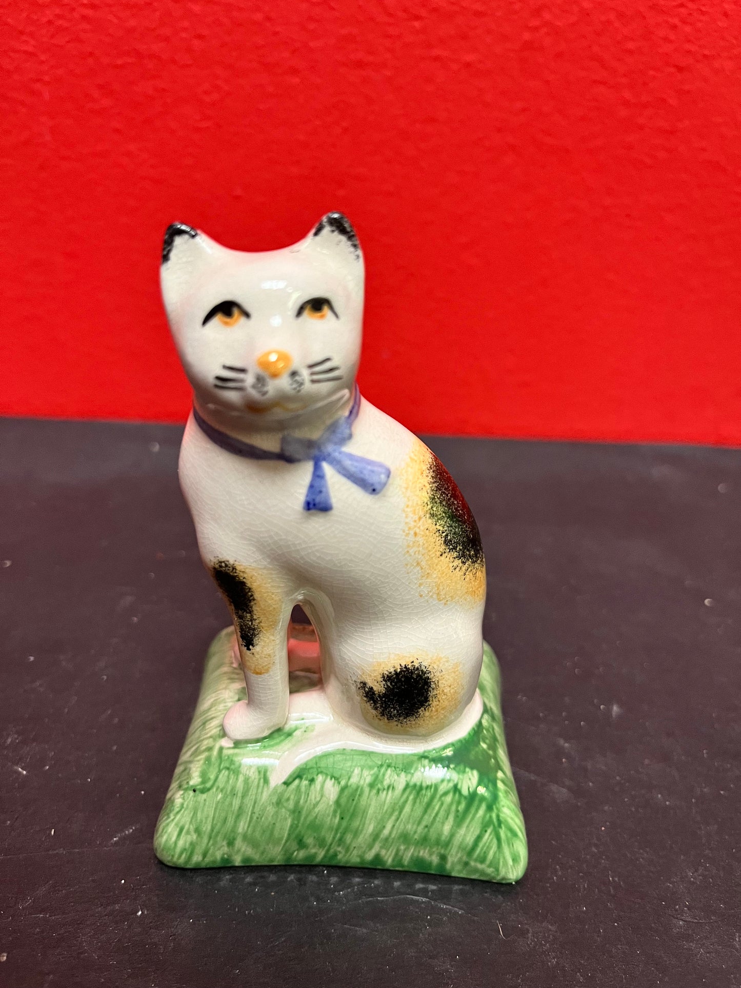 Lovely antique 4 inch high English Staffordshire cat on pillow