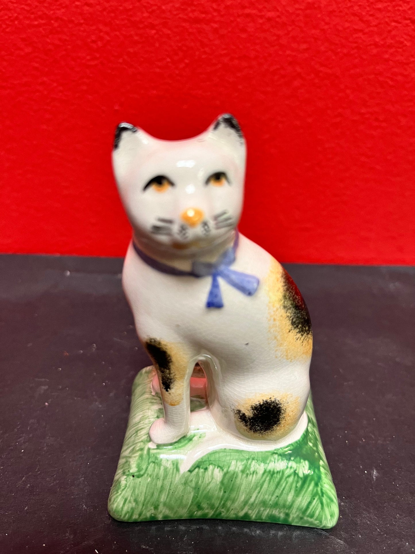 Lovely antique 4 inch high English Staffordshire cat on pillow