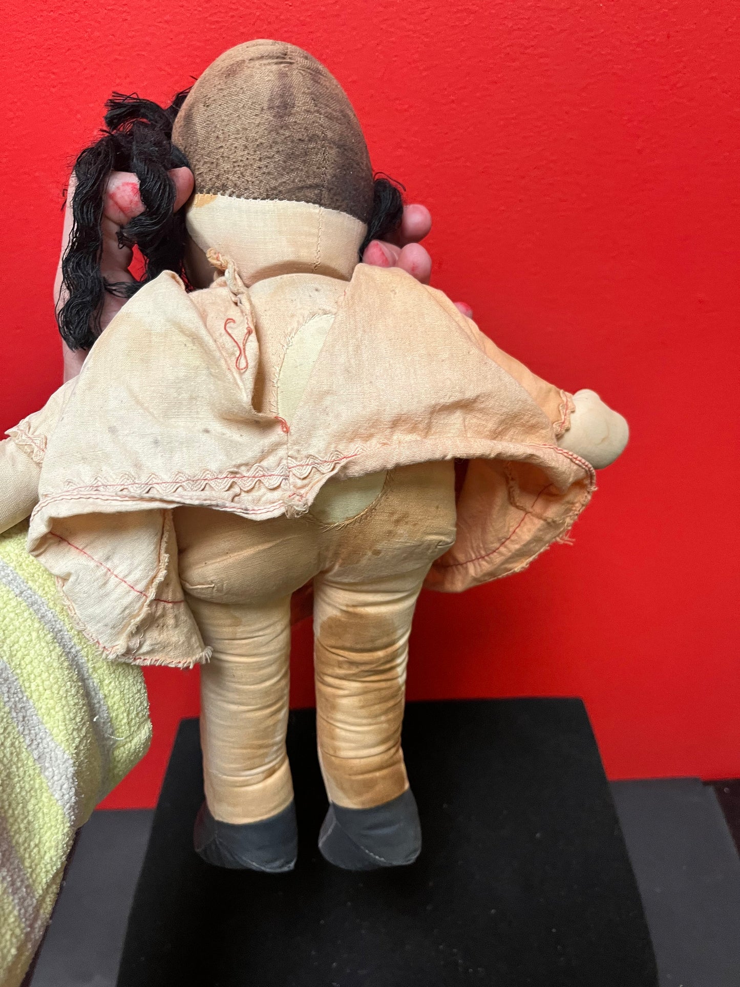 An Antique 15 inch high Lulu doll in bad condition