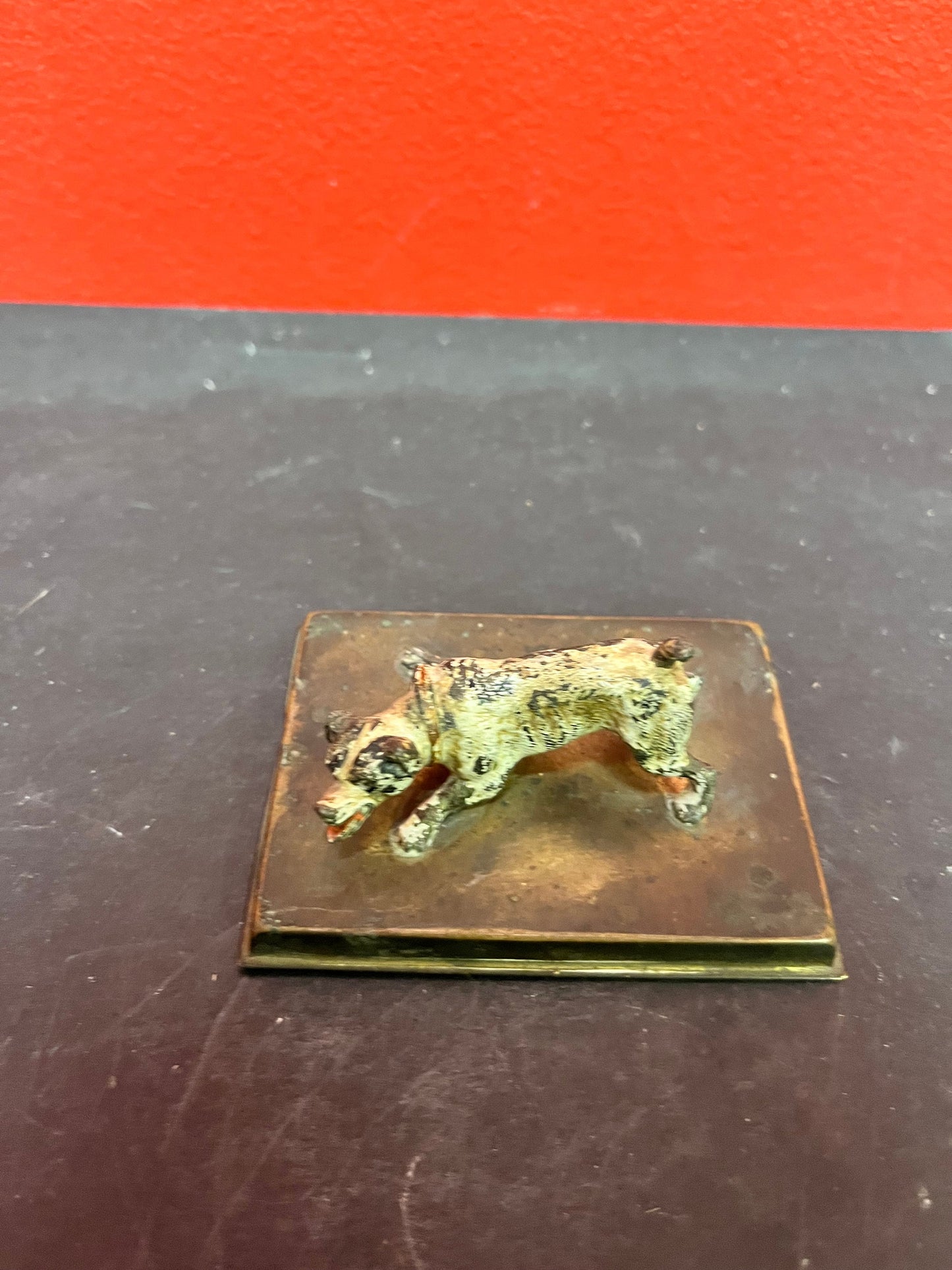 3 inch antique cold, painted bronze dog on stand with registration number good condition and great patina