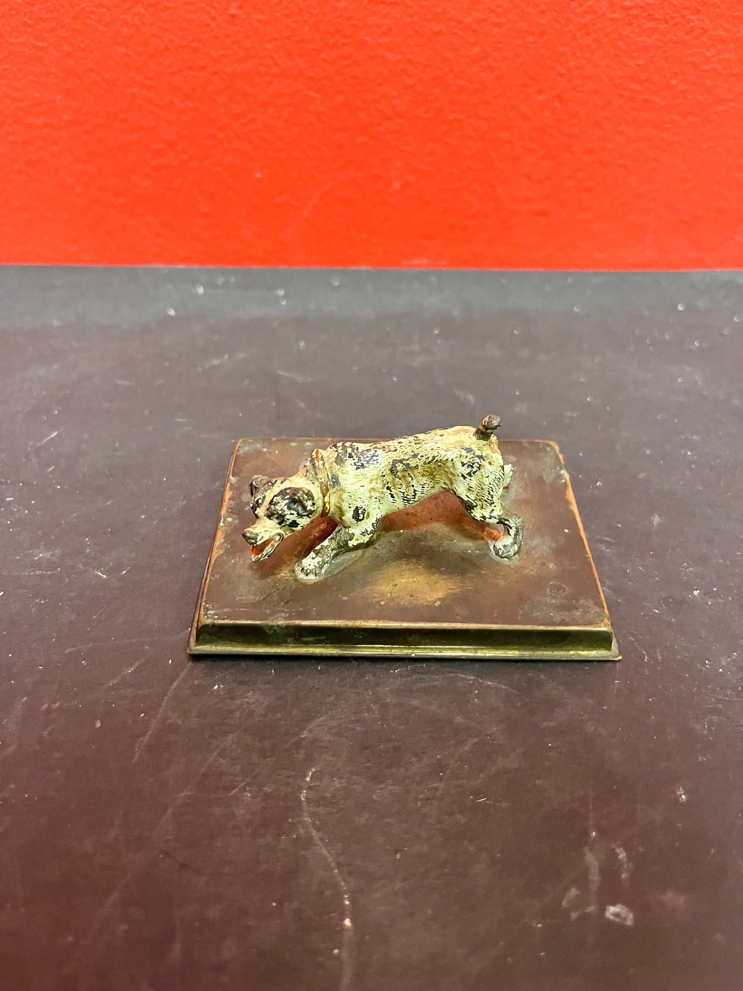 3 inch antique cold, painted bronze dog on stand with registration number good condition and great patina