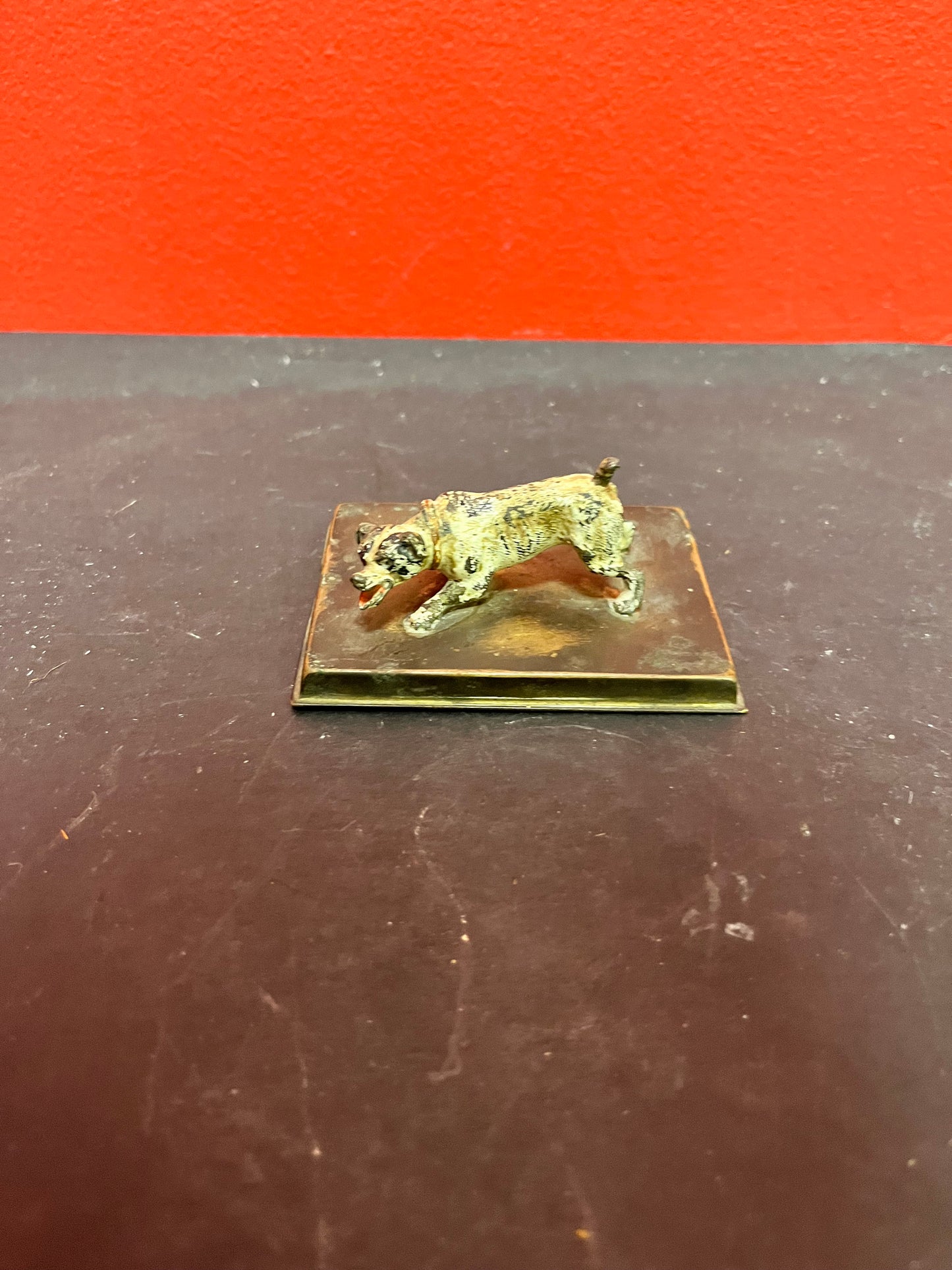 3 inch antique cold, painted bronze dog on stand with registration number good condition and great patina