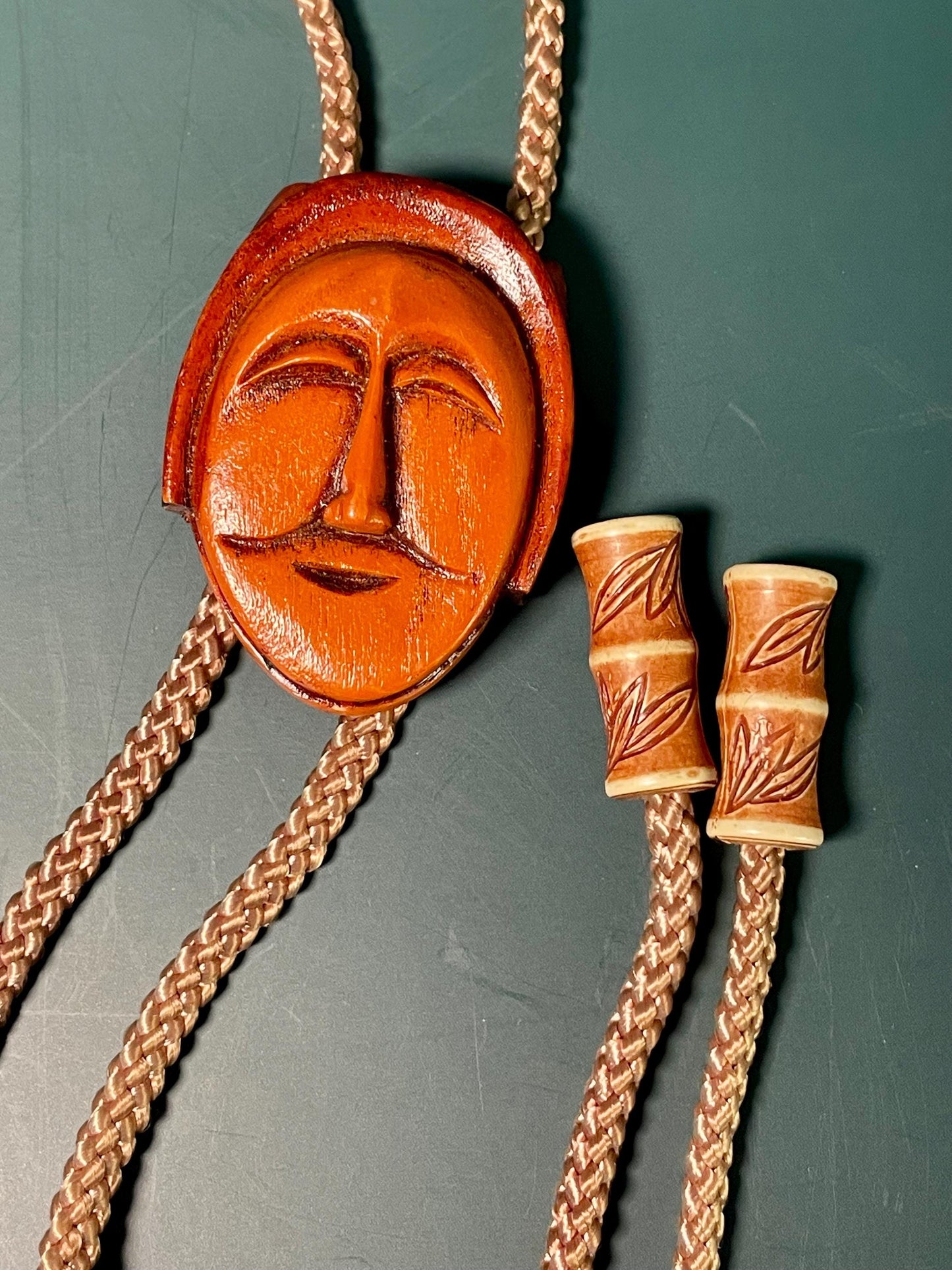 38 Bolo Tie with Carved Face and Accent Beads