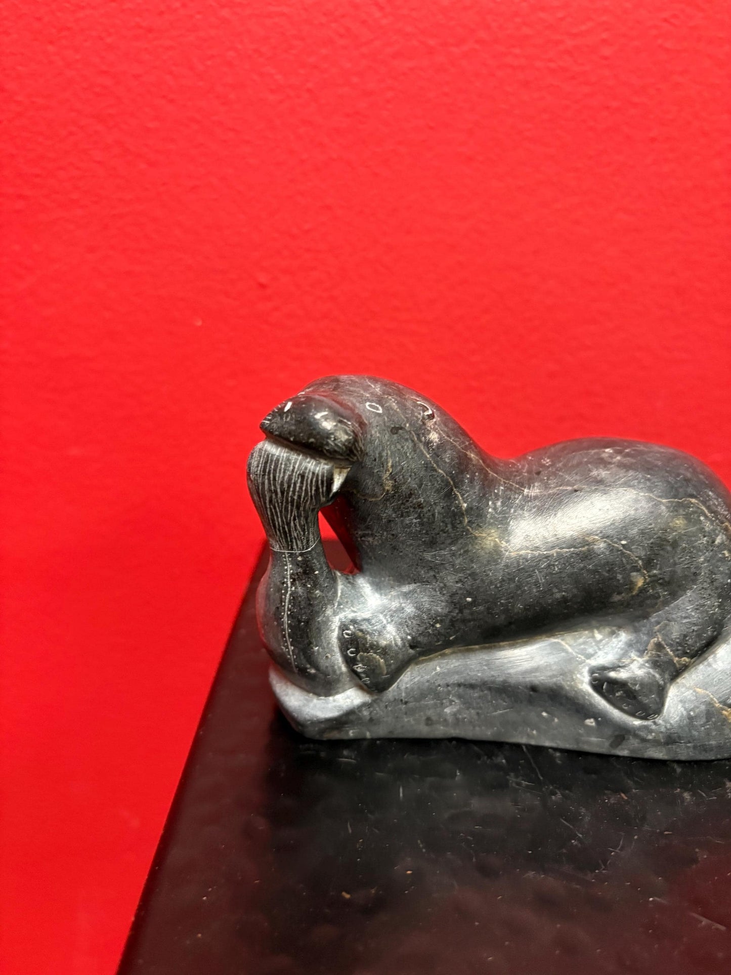 Beautiful old soapstone seal on log with fish in Mouth   7 inches long signed in good condition indigenous Inuit