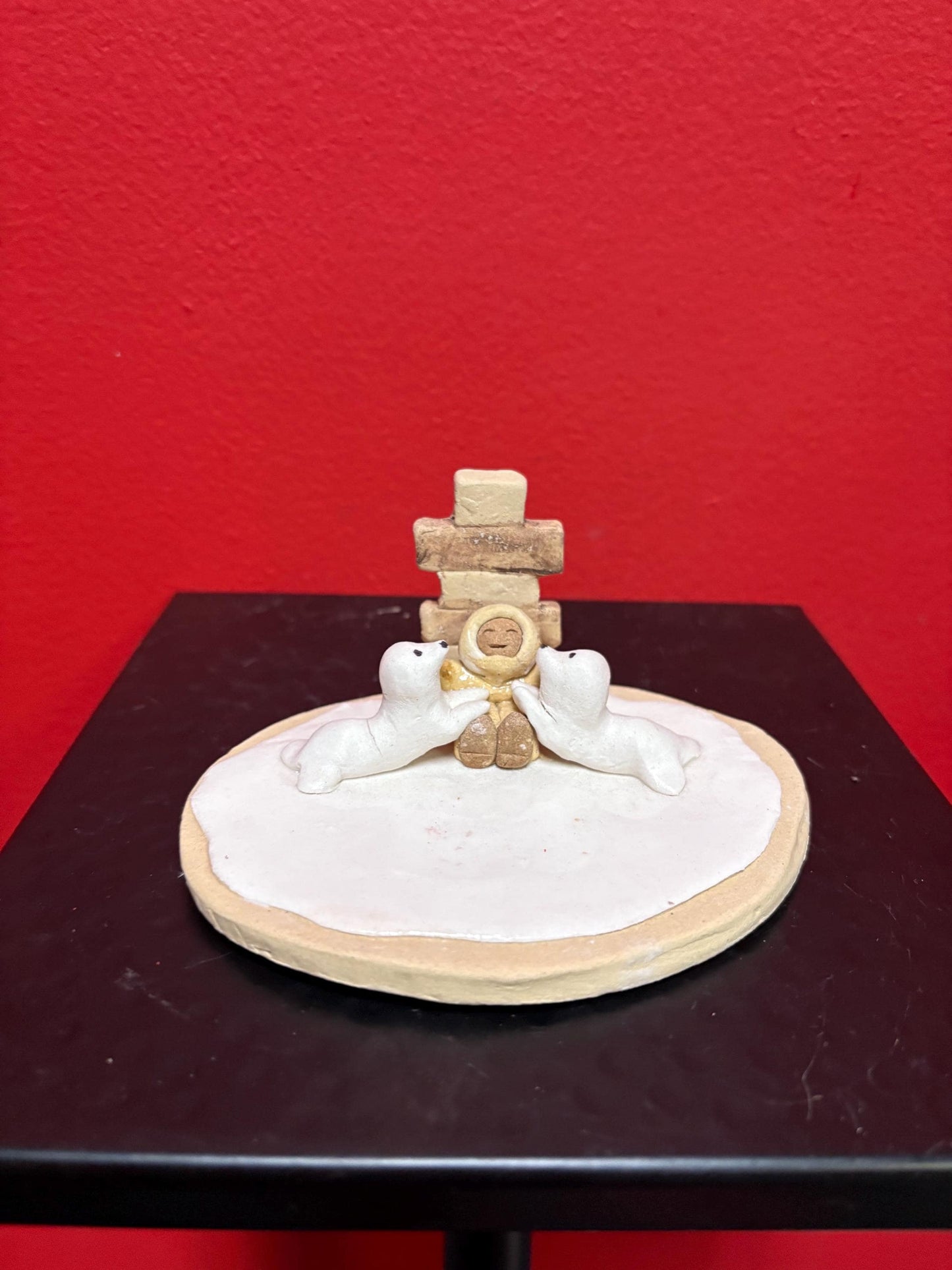 Beautiful indigenous statue of an Eskimo and seals and an Inukshuk  5 x 2 1/2“ high signed  2 available