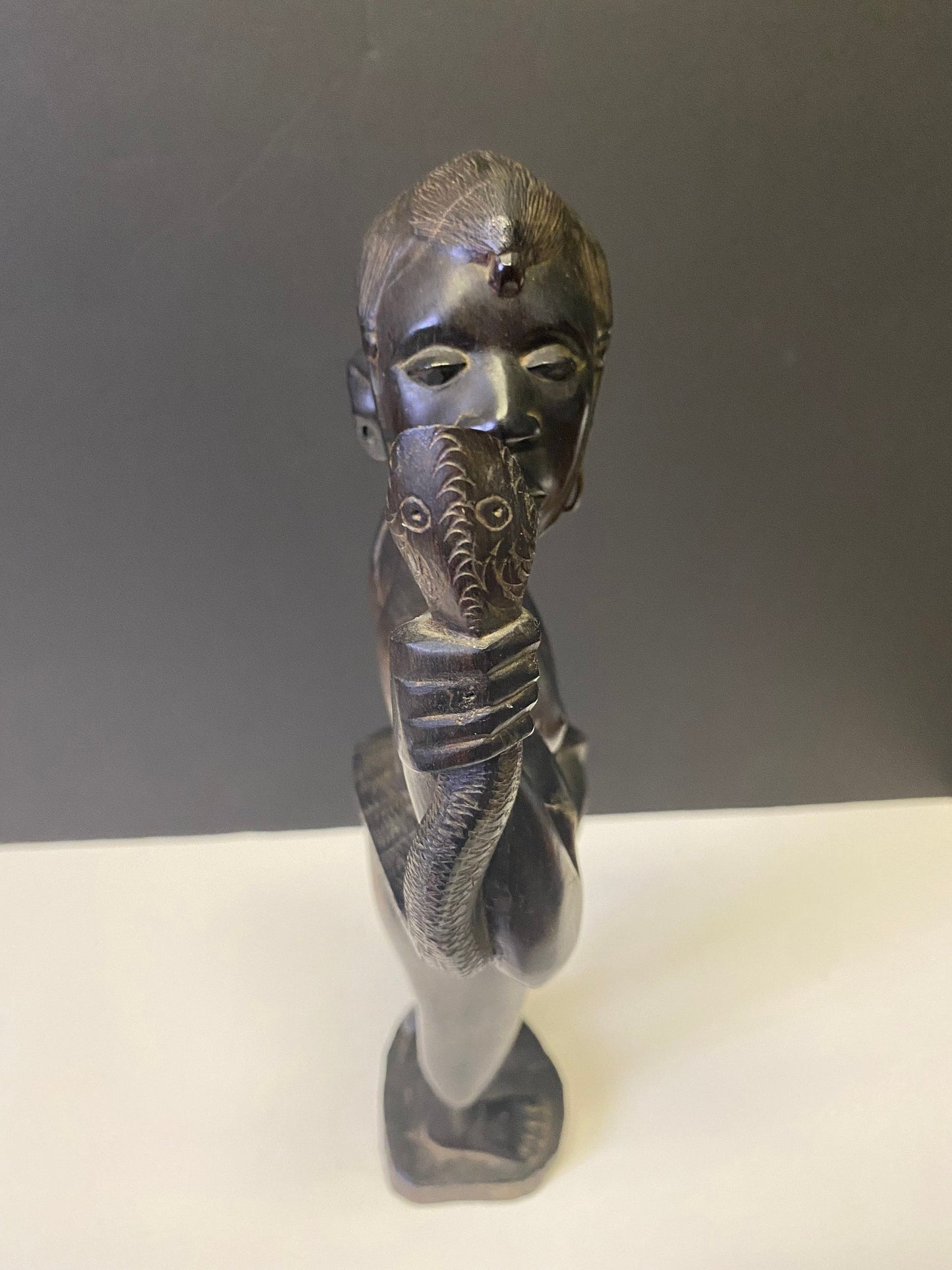 Absolutely spectacular 16 inch tall western African ebony statue of a snake charmer