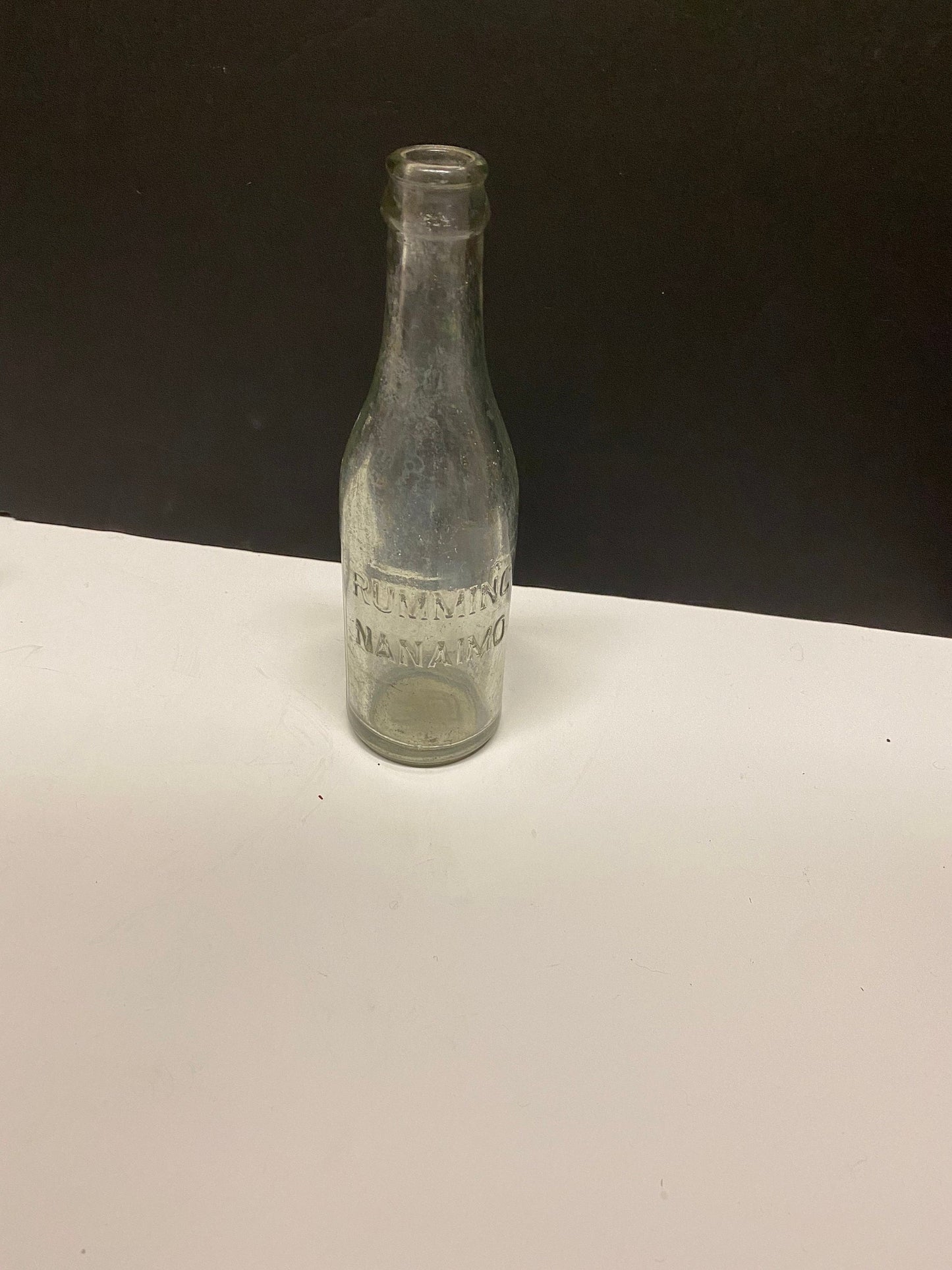 A  8 inch rumming nanaimo clear bottle  Canadian island bottle history  Dirty but good condition rare