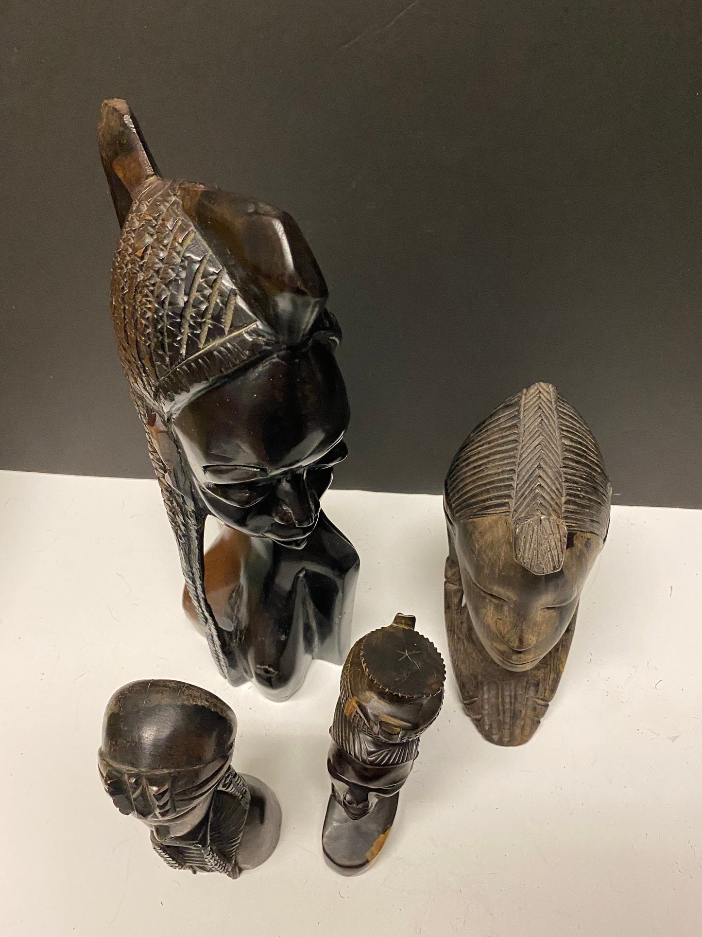 A  Collection of four wonderful hardwood ebony African female busts  6 to 13 inches  1500g of carved wood  wow wow wow