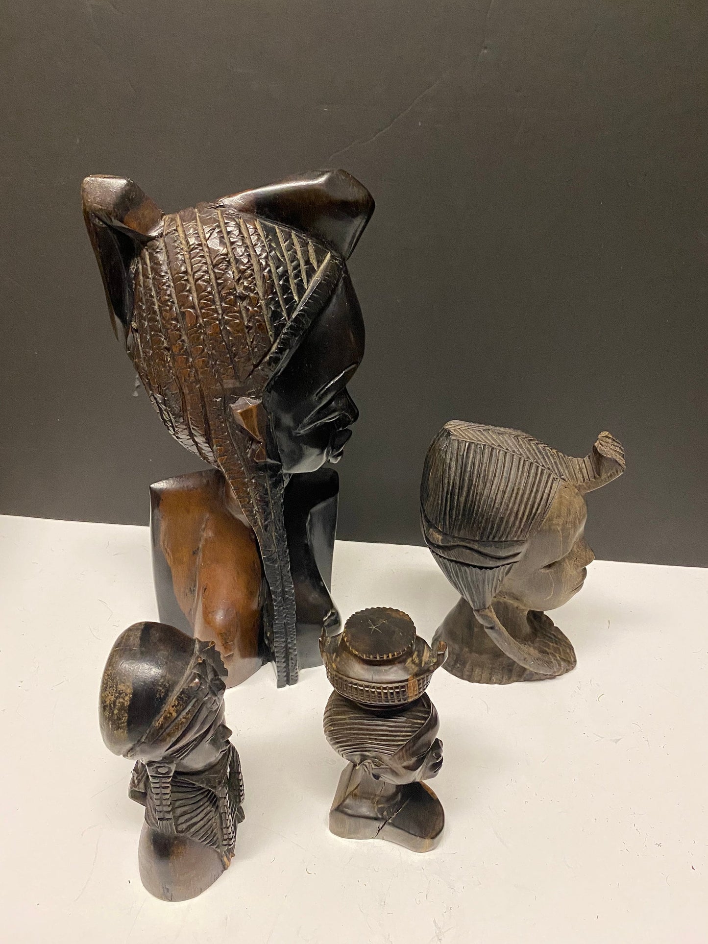 A  Collection of four wonderful hardwood ebony African female busts  6 to 13 inches  1500g of carved wood  wow wow wow