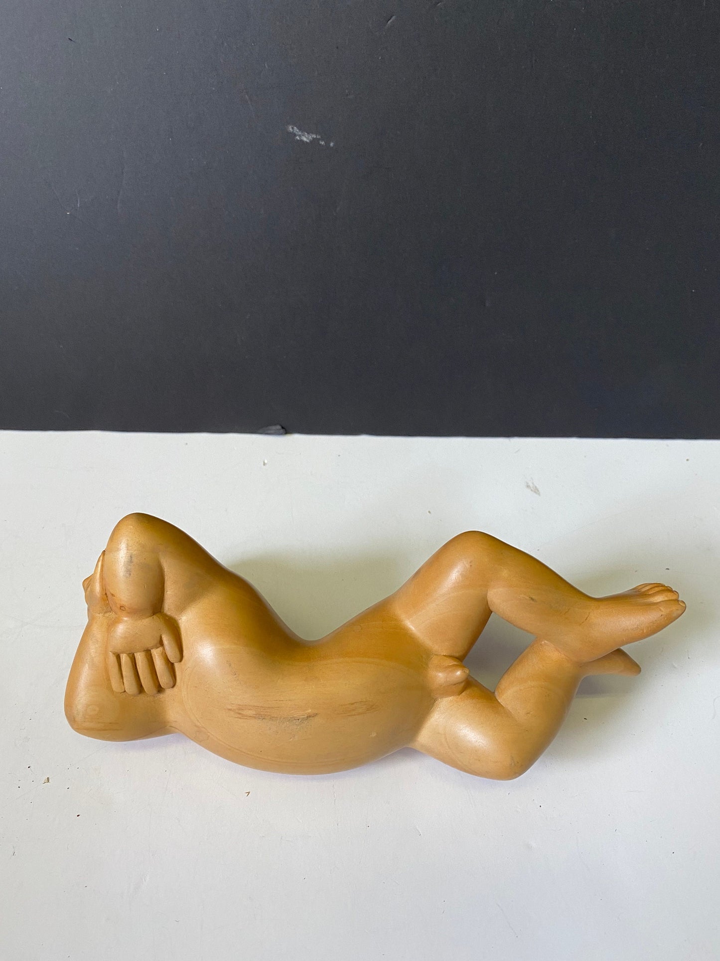 A  Fabulous older Indonesian Carved statue of a man reclining  Top notch Carving and detail  Unbelievable piece