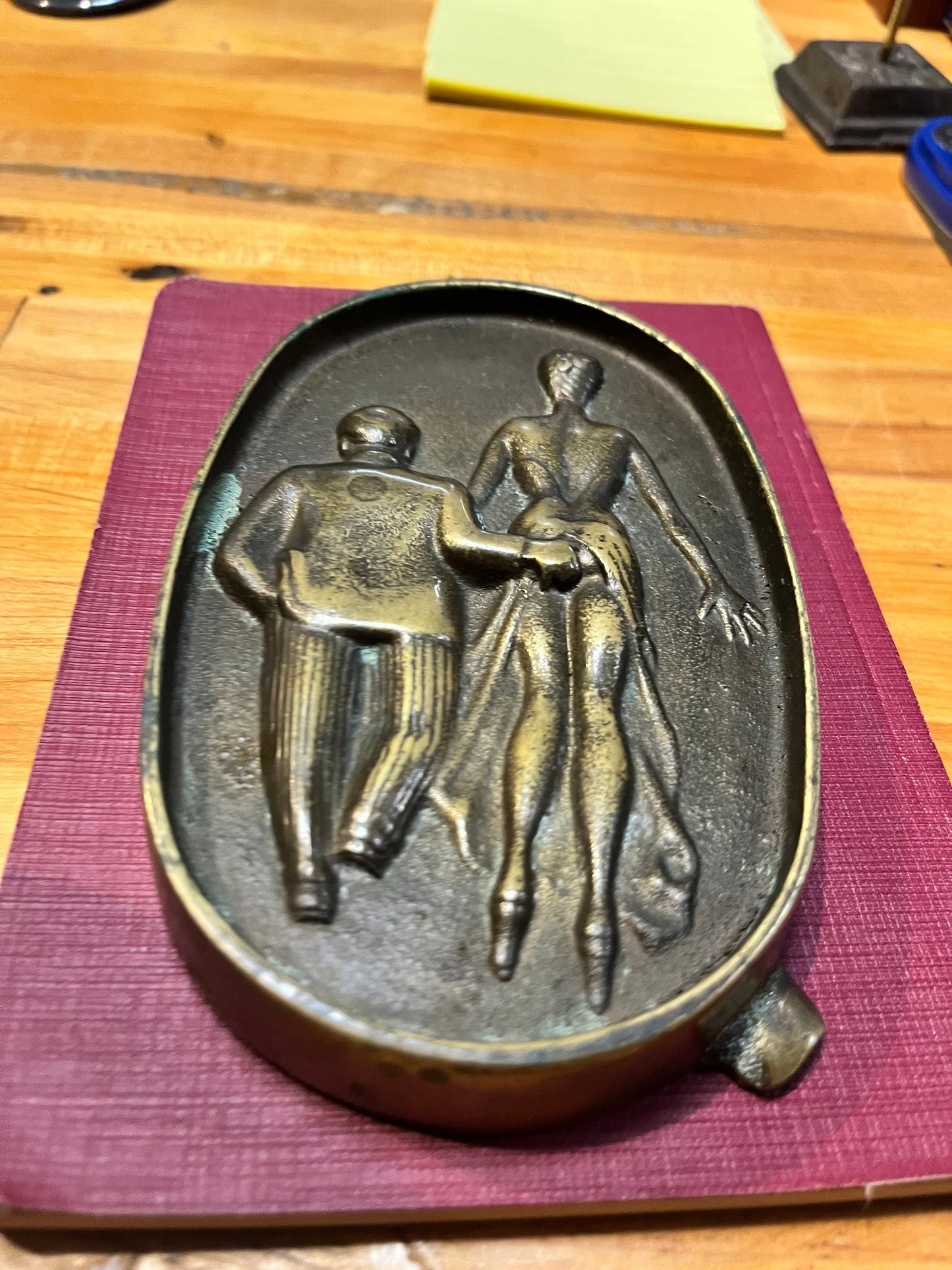 5.5 inch long  antique naughty bronze ashtray  amazing patina and such a cool piece.