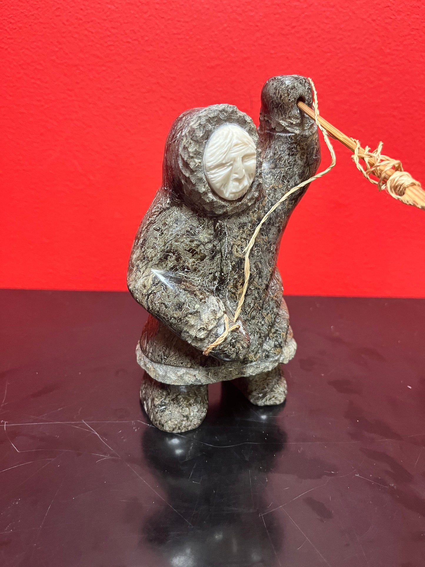 A  Fabulous 6 inch tall, authentic indigenous Inuit soapstone hunting statue with carved bone face  antique Inuit soapstone