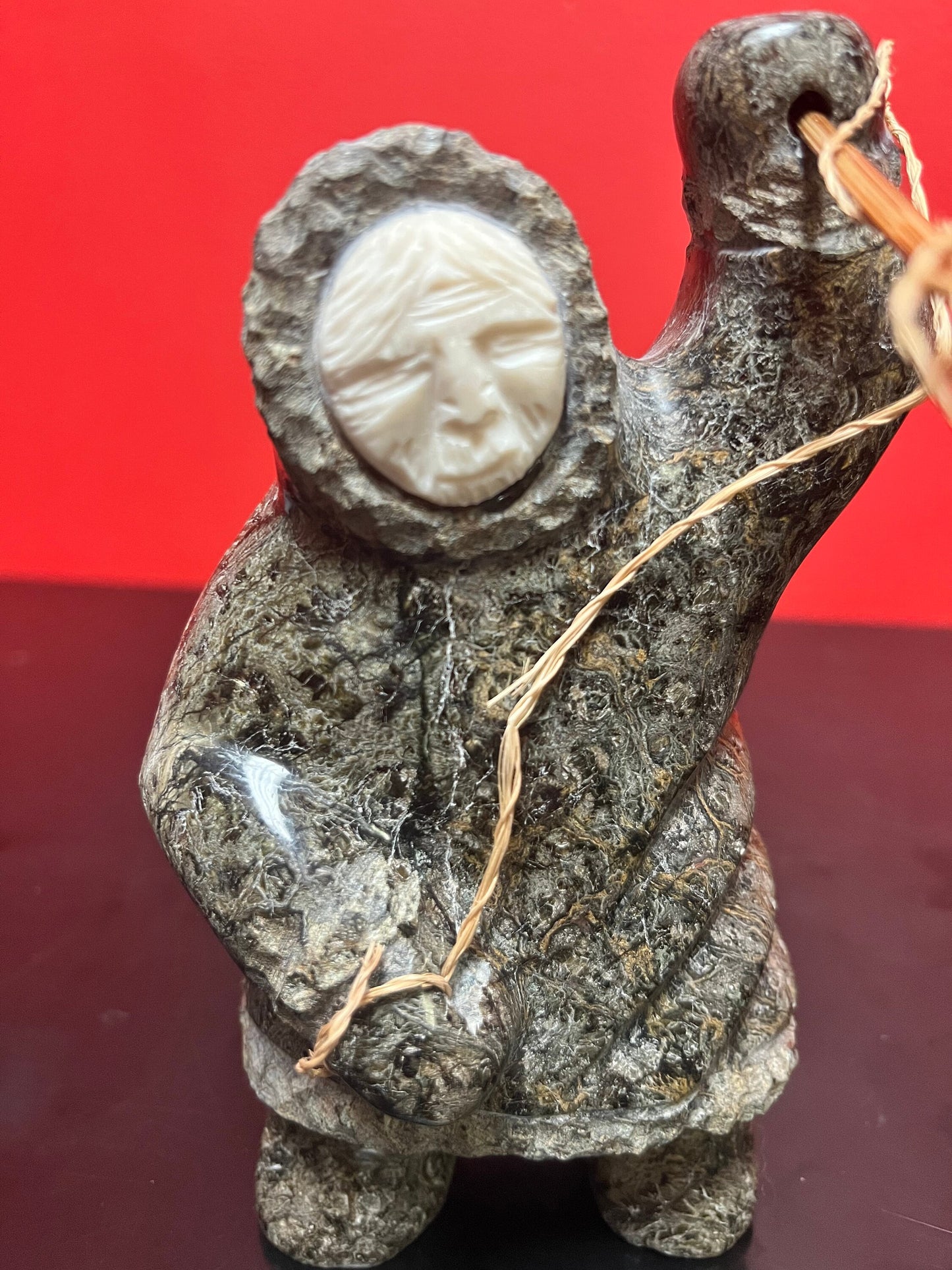 A  Fabulous 6 inch tall, authentic indigenous Inuit soapstone hunting statue with carved bone face  antique Inuit soapstone