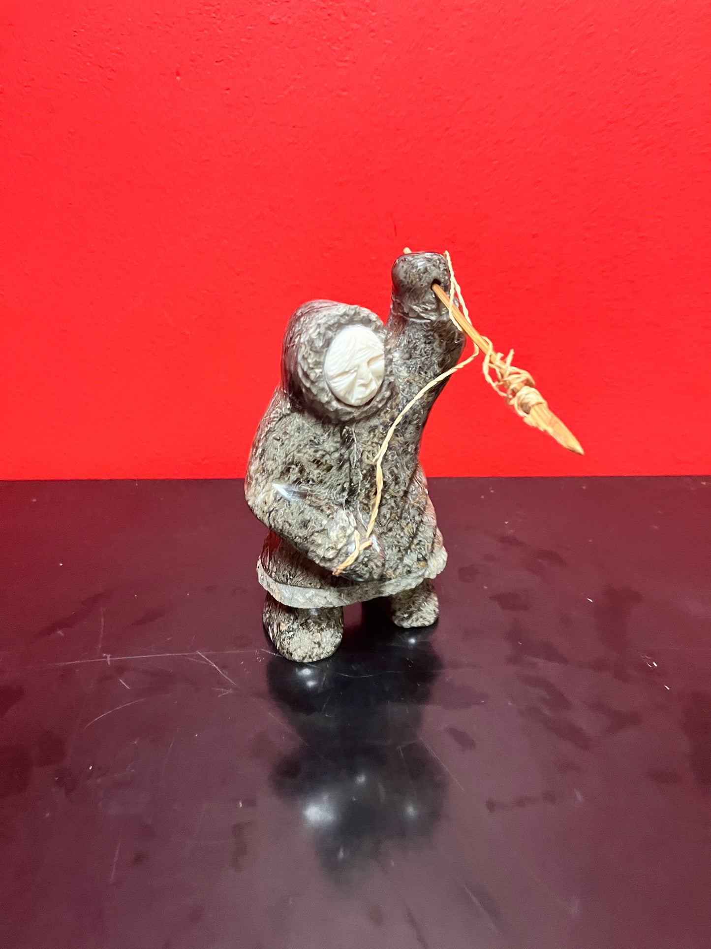 A  Fabulous 6 inch tall, authentic indigenous Inuit soapstone hunting statue with carved bone face  antique Inuit soapstone