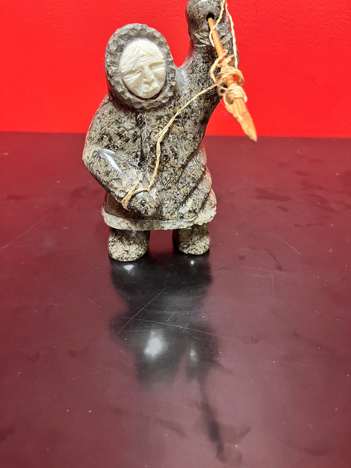 A  Fabulous 6 inch tall, authentic indigenous Inuit soapstone hunting statue with carved bone face  antique Inuit soapstone