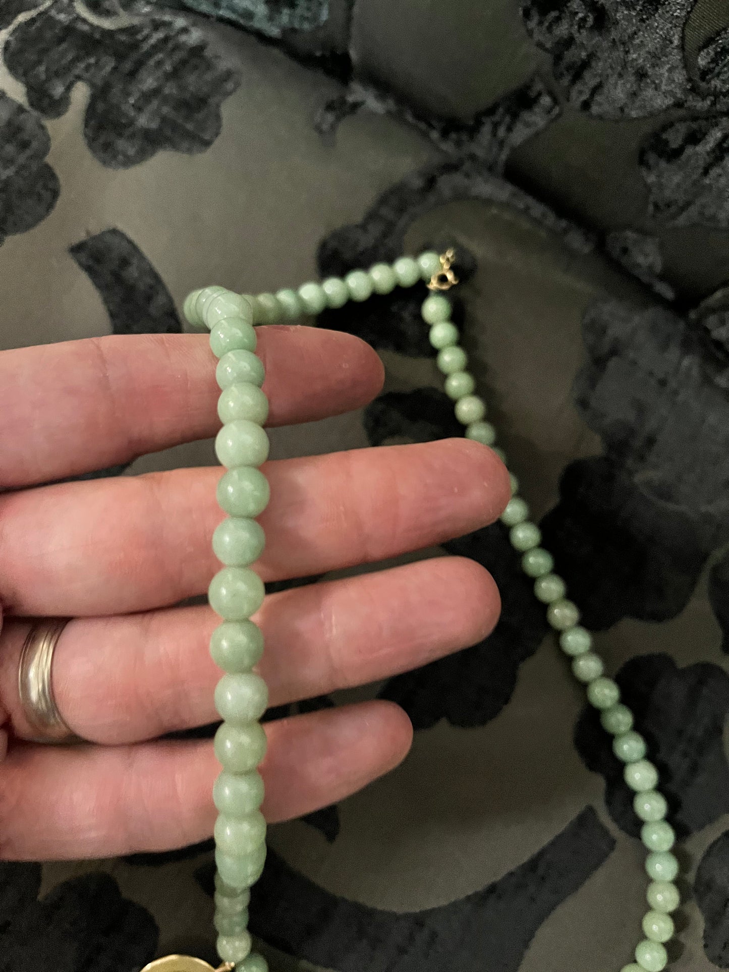 Approx 26 inch long jade necklace with untested gold pendant -