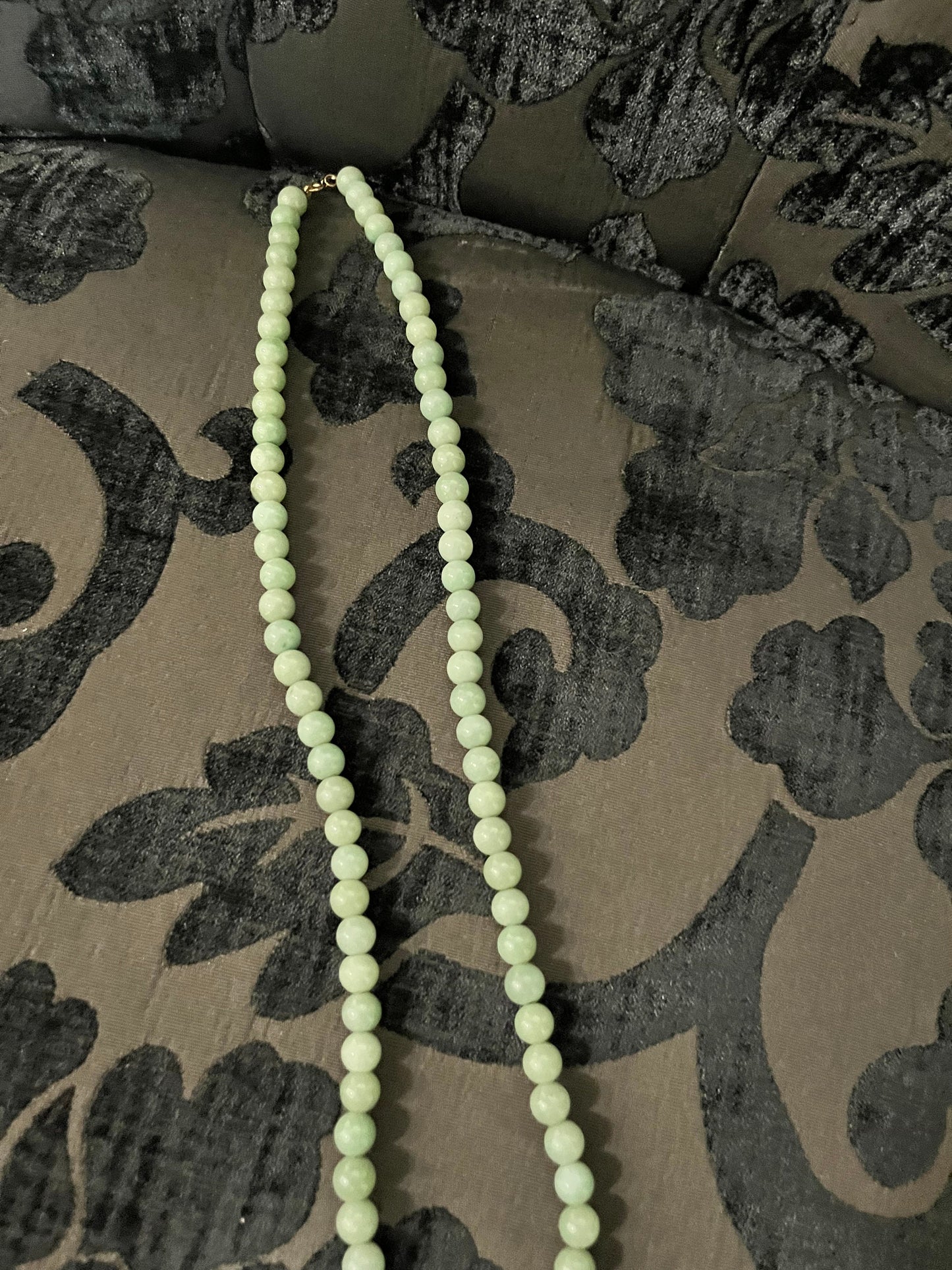 Approx 26 inch long jade necklace with untested gold pendant -