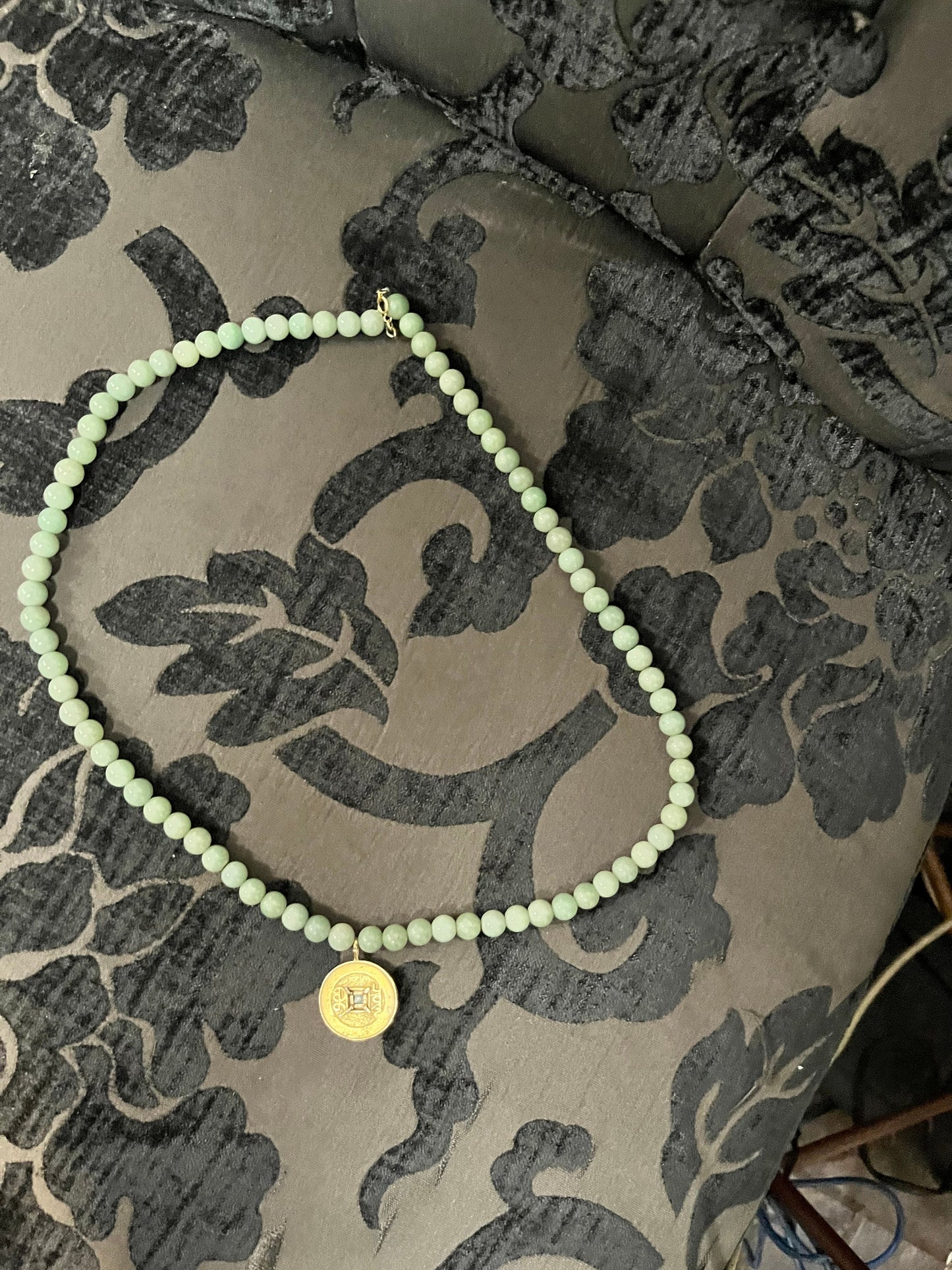 Approx 26 inch long jade necklace with untested gold pendant -