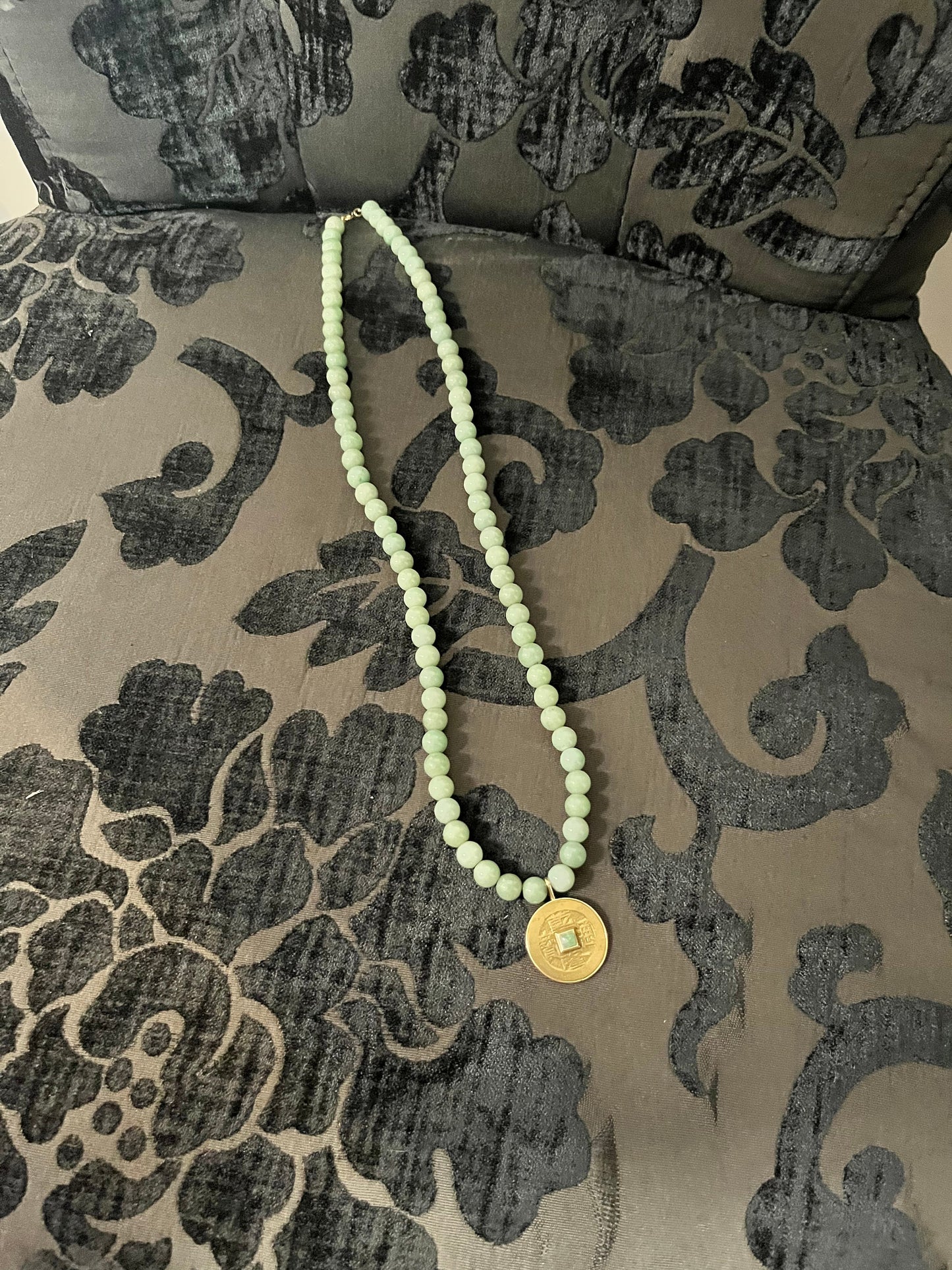 Approx 26 inch long jade necklace with untested gold pendant -