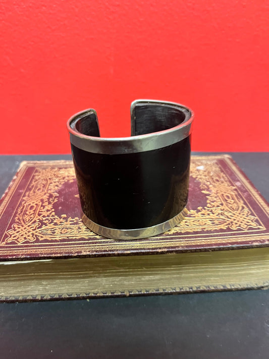 A  3 inch wide silver and horn cool bangle cuff  fits a fairly normal wrist