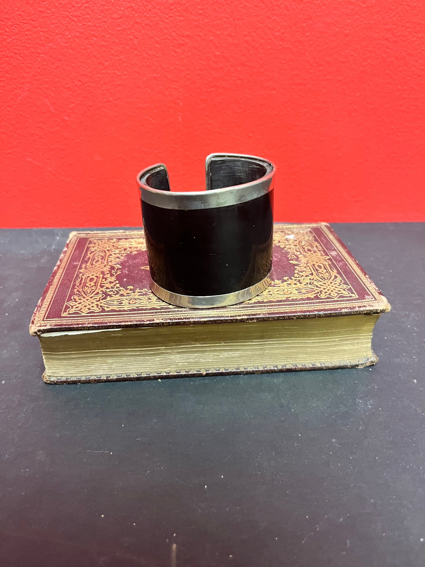 A  3 inch wide silver and horn cool bangle cuff  fits a fairly normal wrist