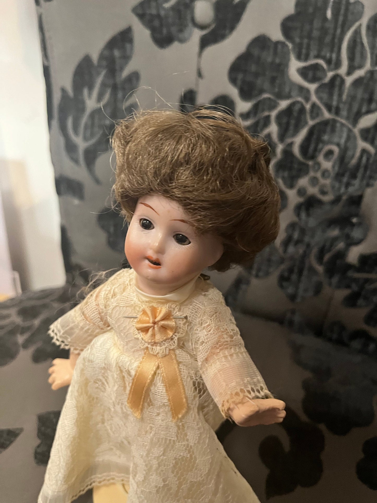 8 1/2 inch Victorian porcelain doll with original clothes on stand