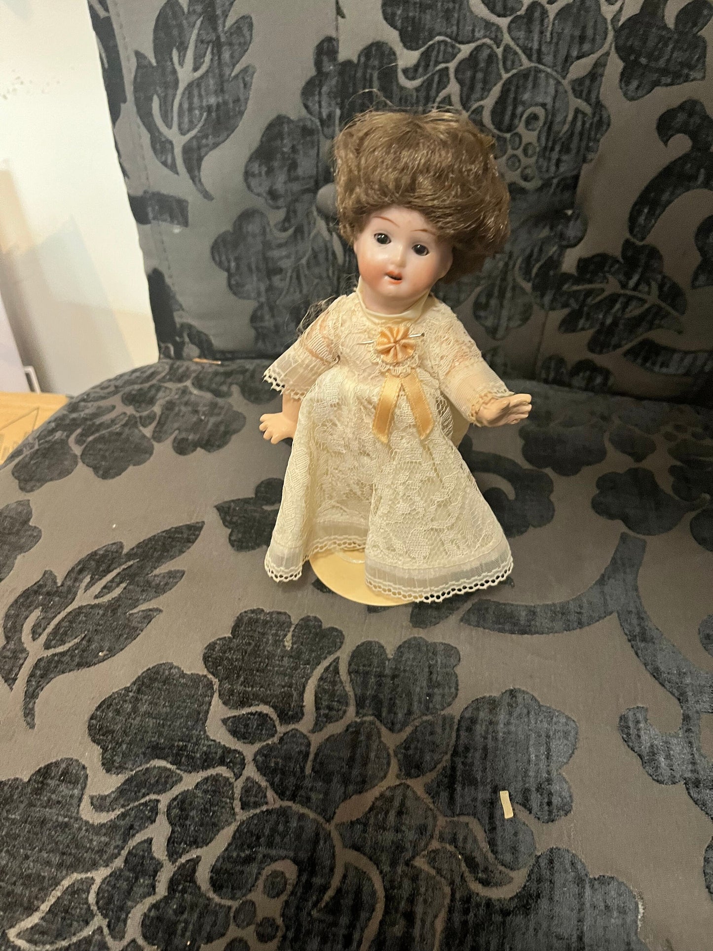 8 1/2 inch Victorian porcelain doll with original clothes on stand
