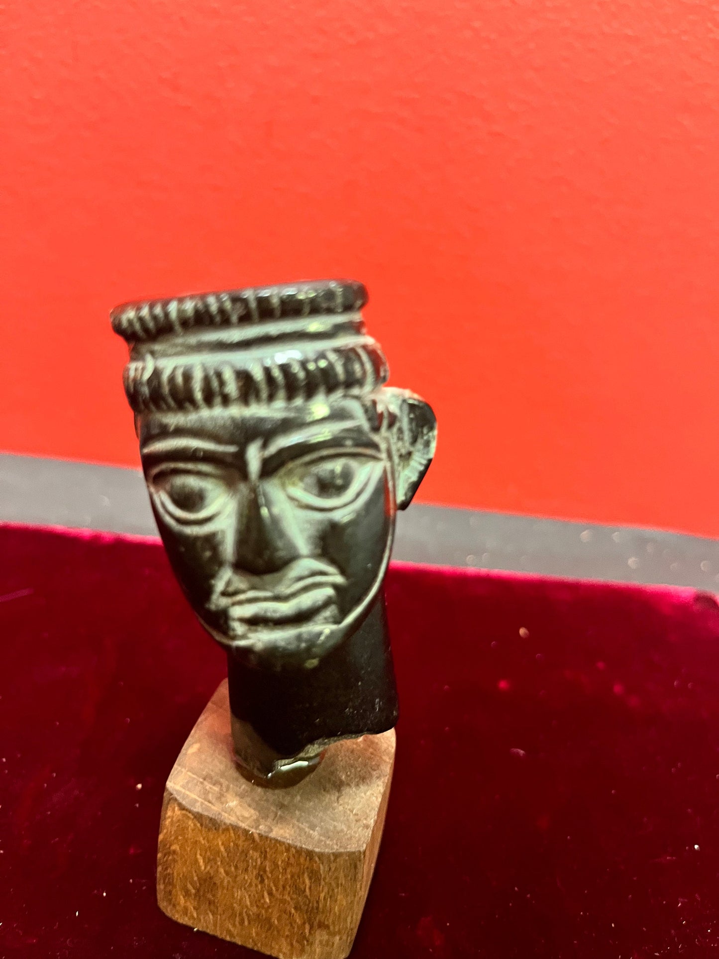 4.5 inch high stone carving on wood base.