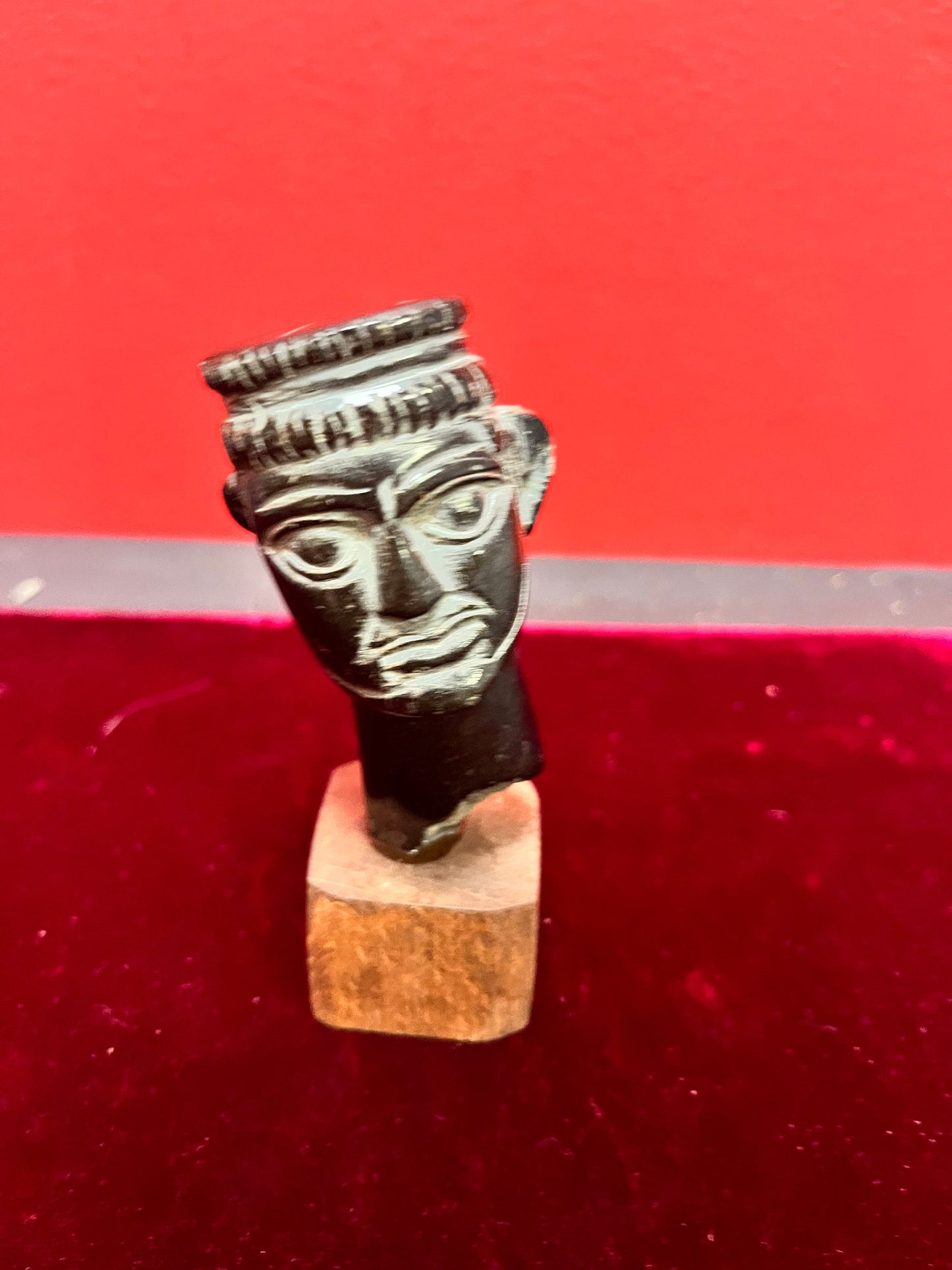 4.5 inch high stone carving on wood base.