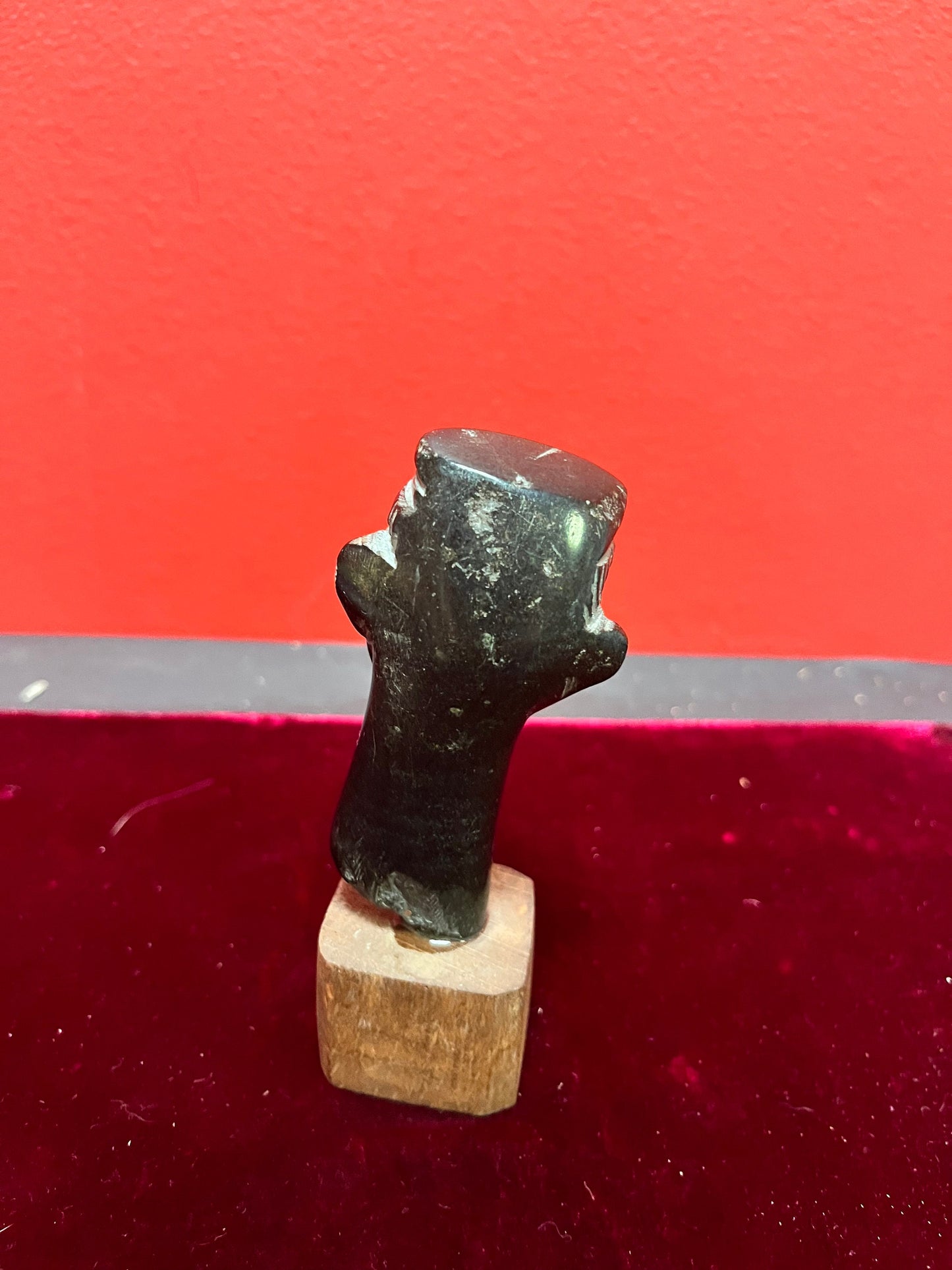 4.5 inch high stone carving on wood base.