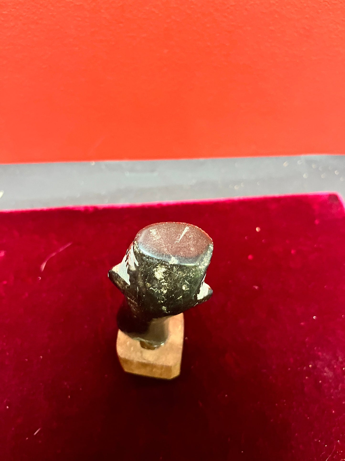 4.5 inch high stone carving on wood base.