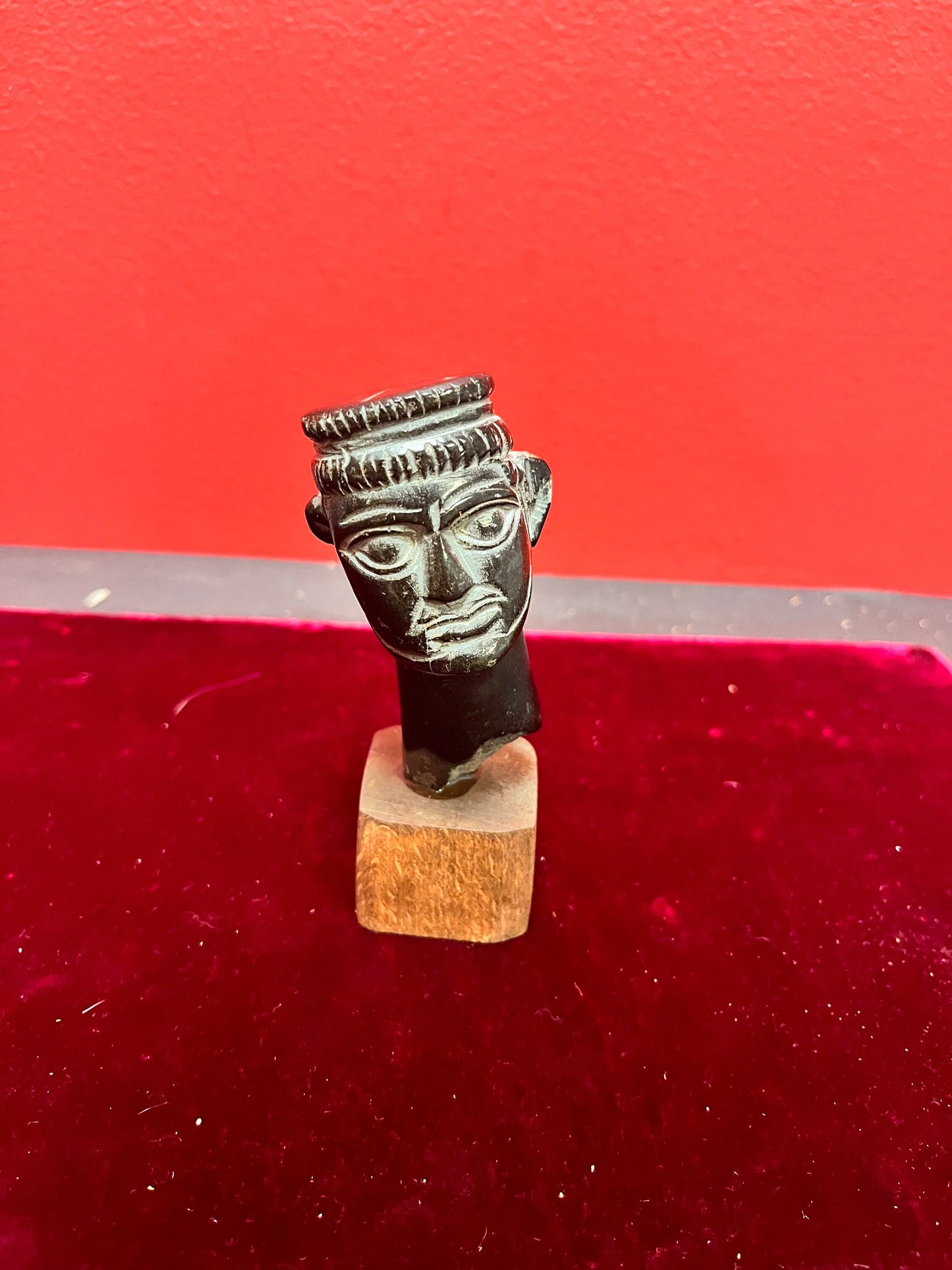 4.5 inch high stone carving on wood base.