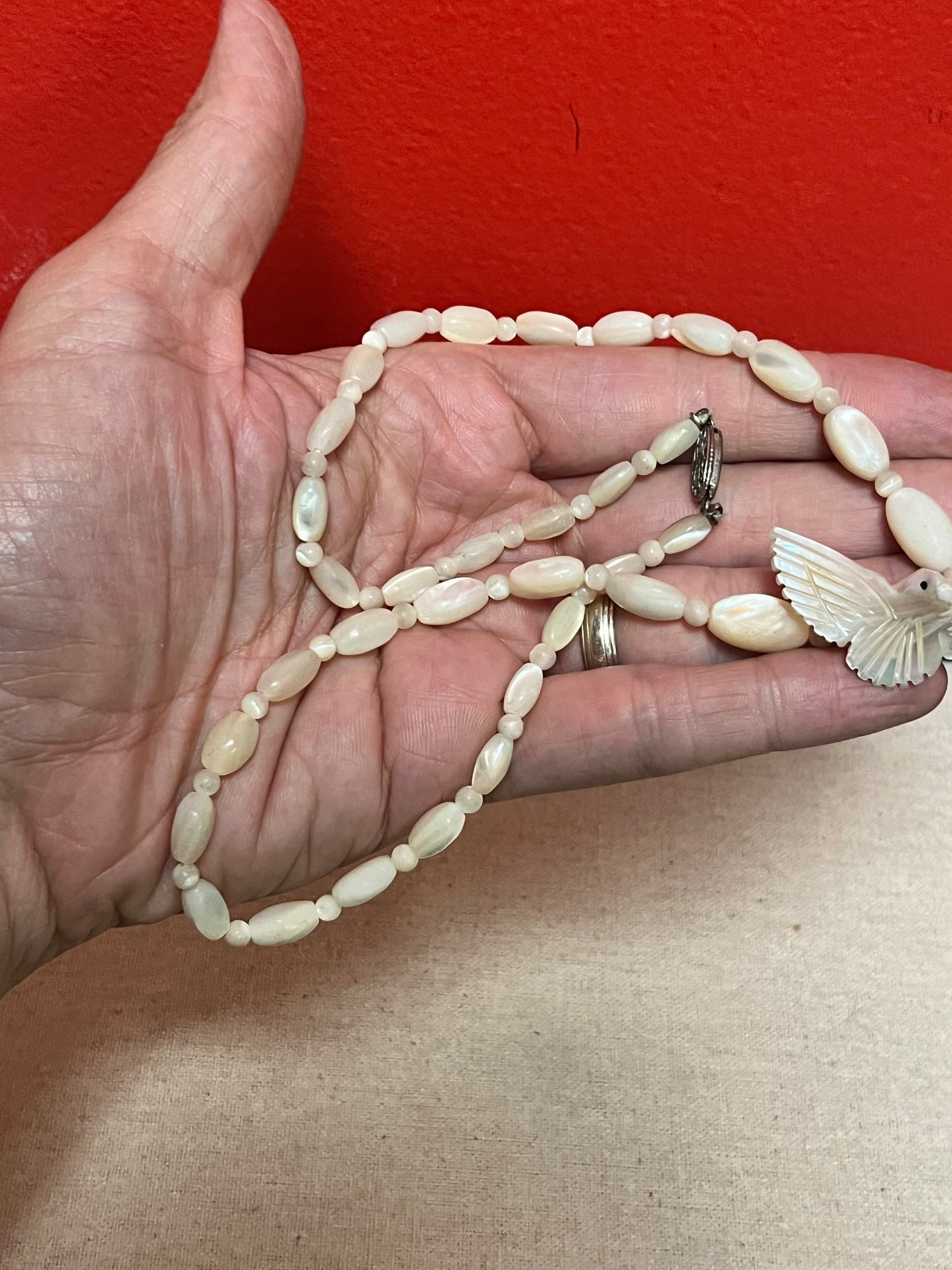 Approximately 21 inch carved shell necklace with bird pendant  lovely detail