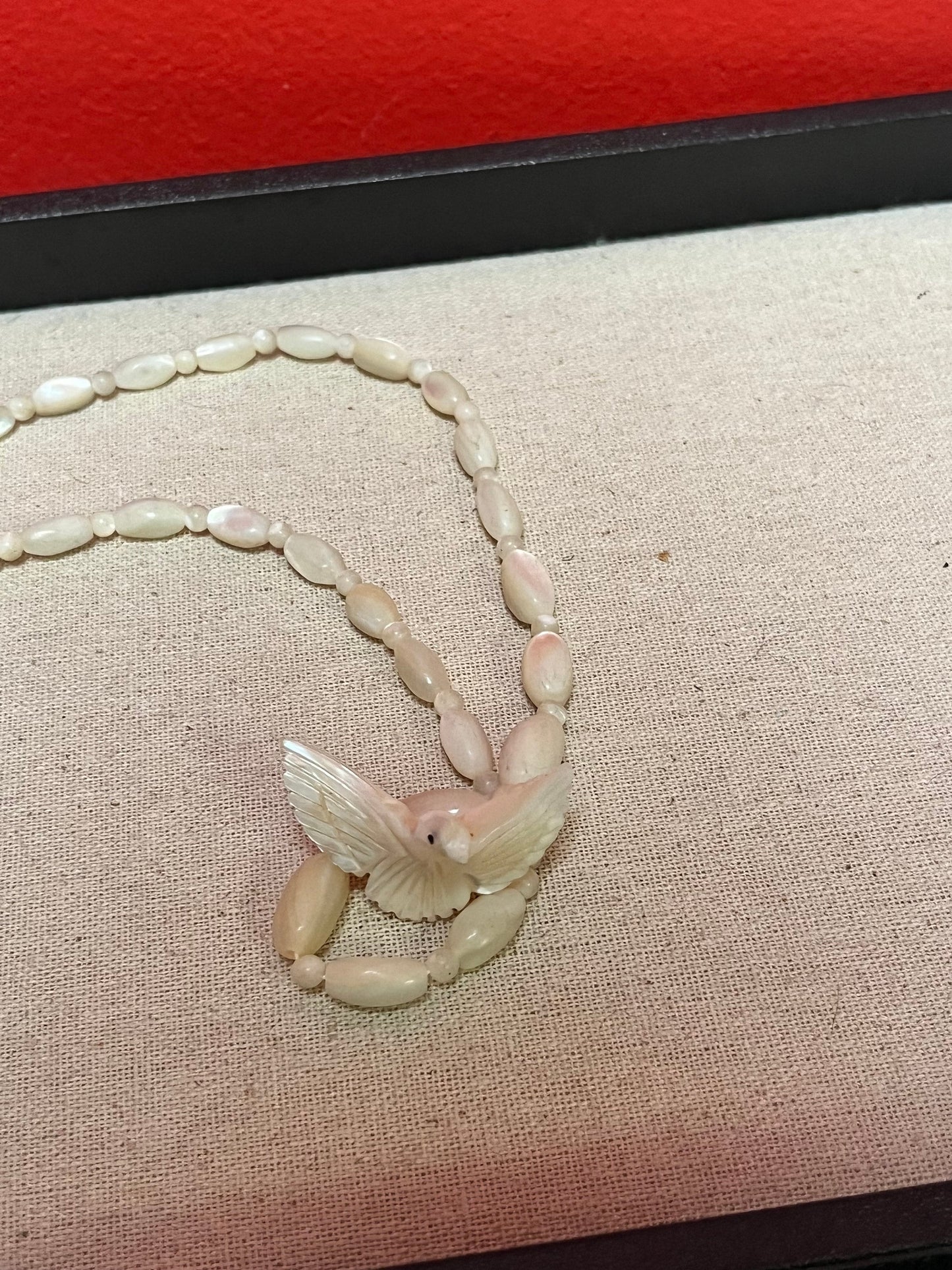 Approximately 21 inch carved shell necklace with bird pendant  lovely detail