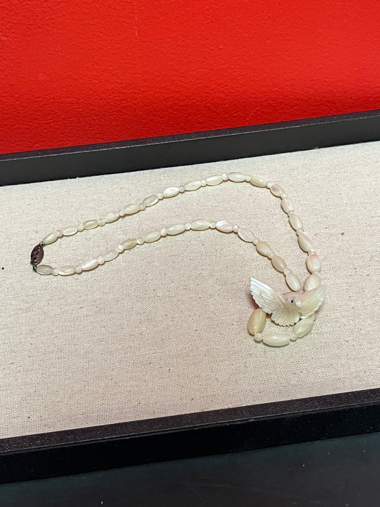 Approximately 21 inch carved shell necklace with bird pendant  lovely detail