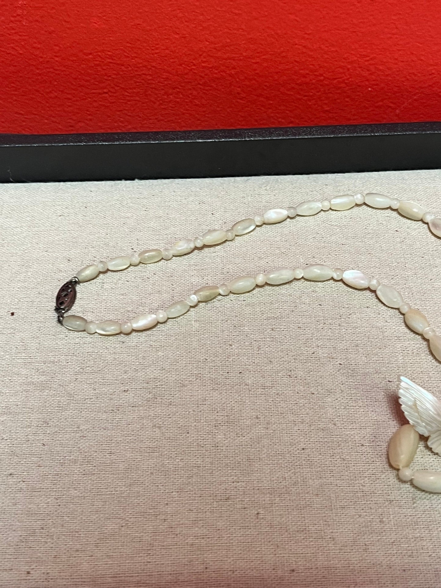 Approximately 21 inch carved shell necklace with bird pendant  lovely detail