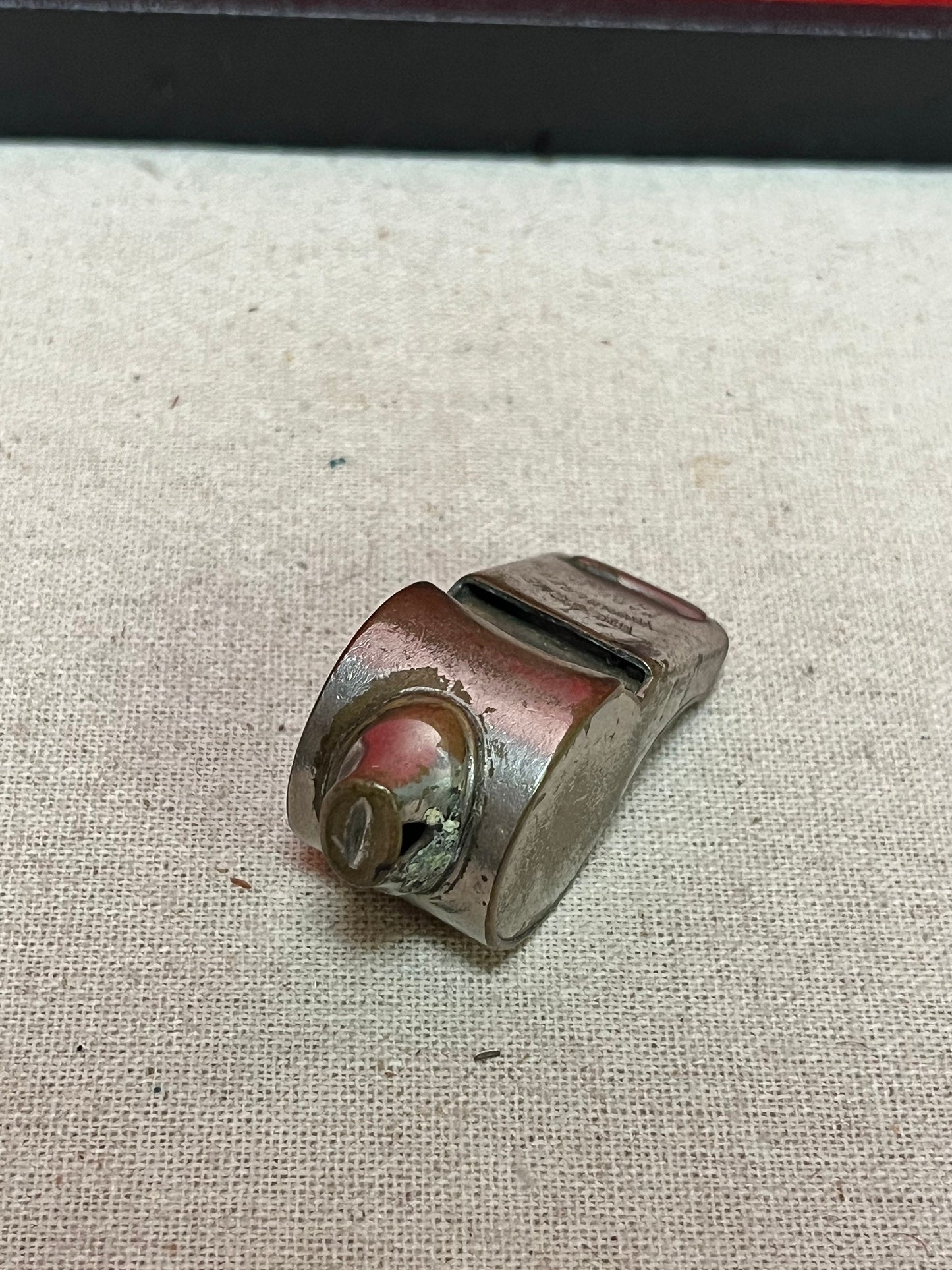 A  The acme thunderer whistle  2 inches long in worn condition