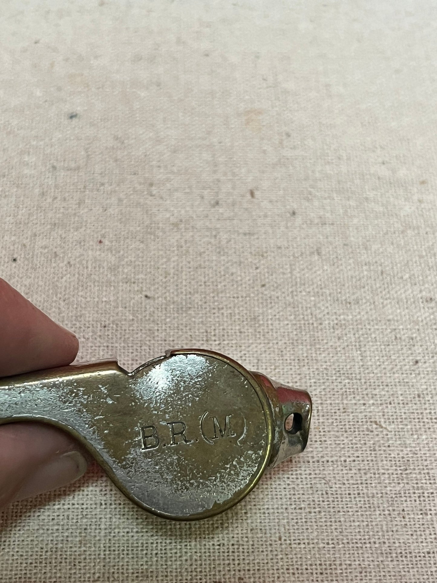 A  The acme thunderer whistle  2 inches long in worn condition