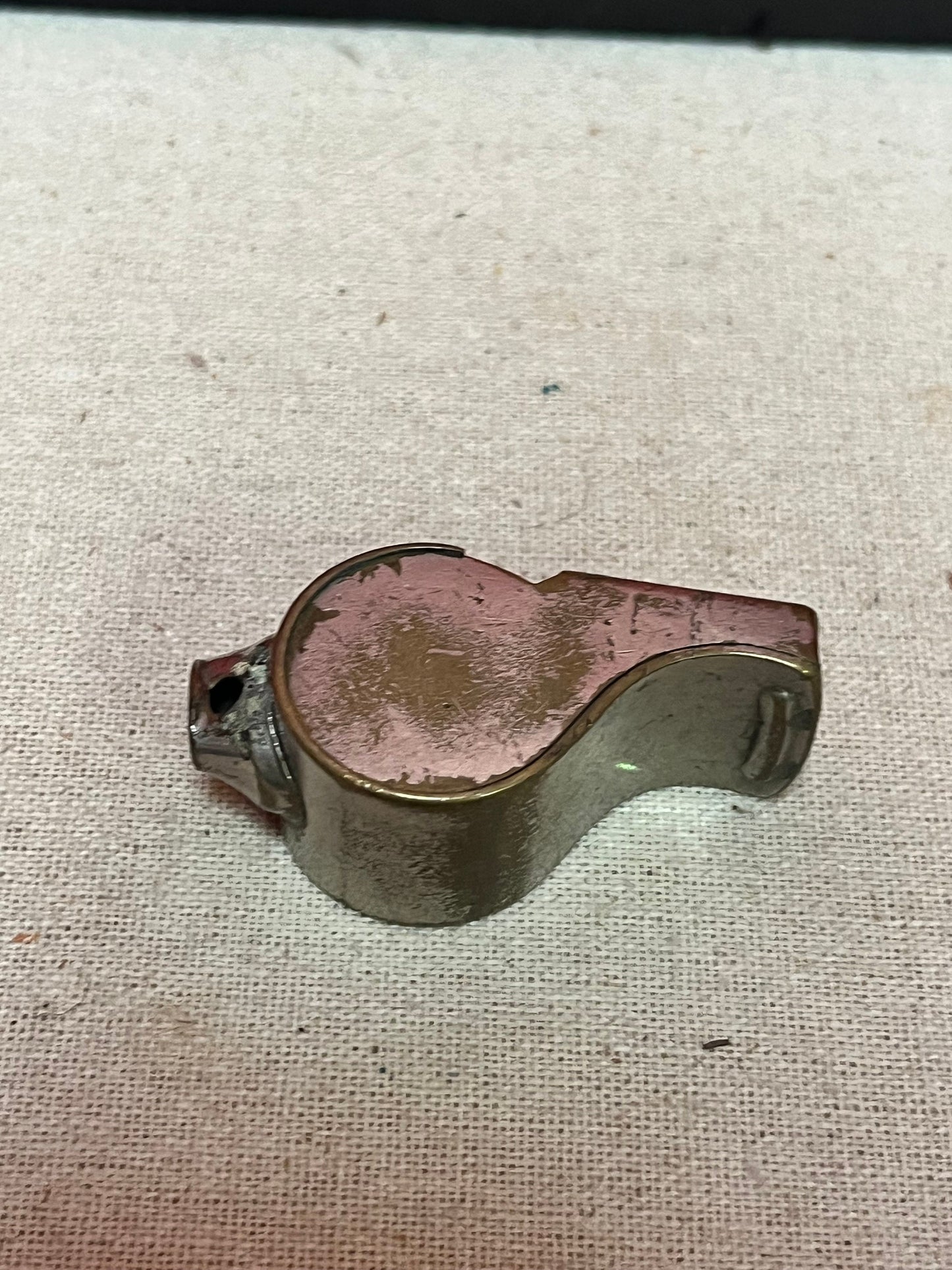 A  The acme thunderer whistle  2 inches long in worn condition