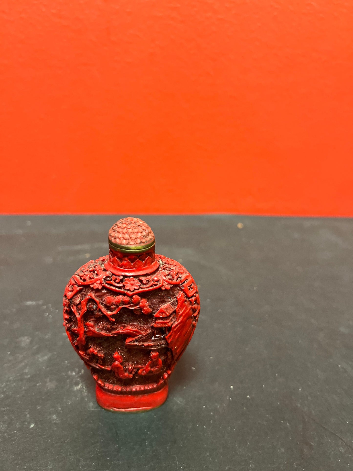 A  Chinese 3 inch high well detailed cinnabar  snuff bottle  great condition, but top is stuck.  low price
