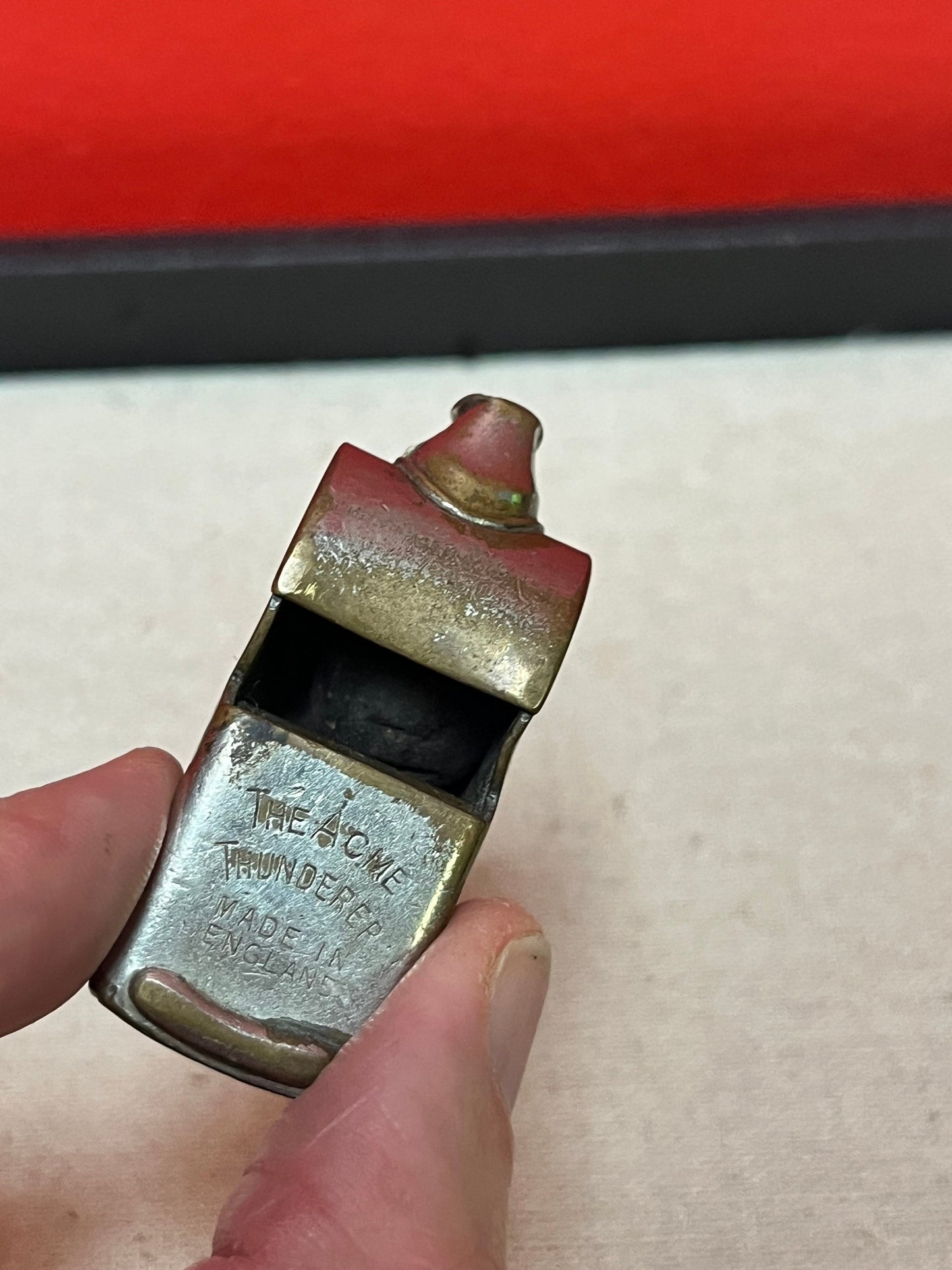 A  The acme thunderer whistle  2 inches long in worn condition