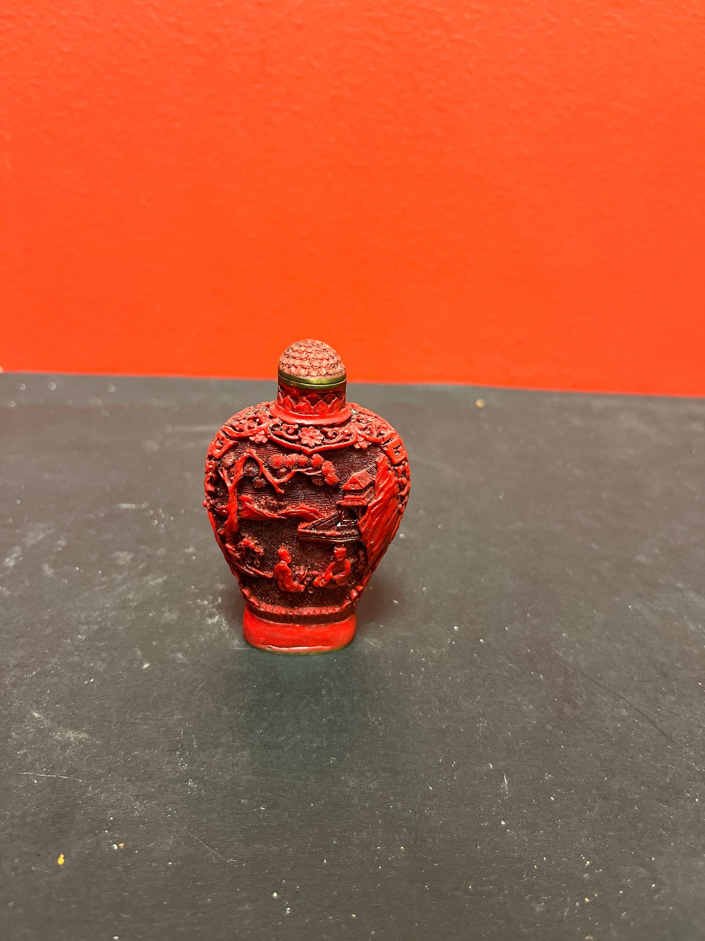 A  Chinese 3 inch high well detailed cinnabar  snuff bottle  great condition, but top is stuck.  low price