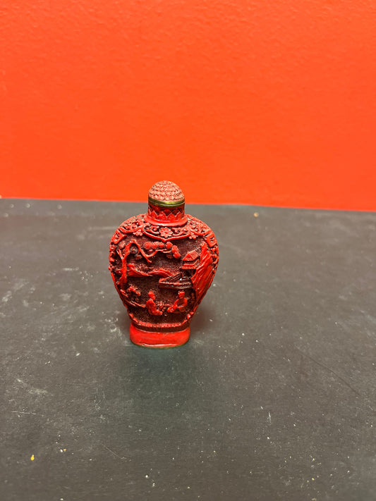 A  Chinese 3 inch high well detailed cinnabar  snuff bottle  great condition, but top is stuck.  low price